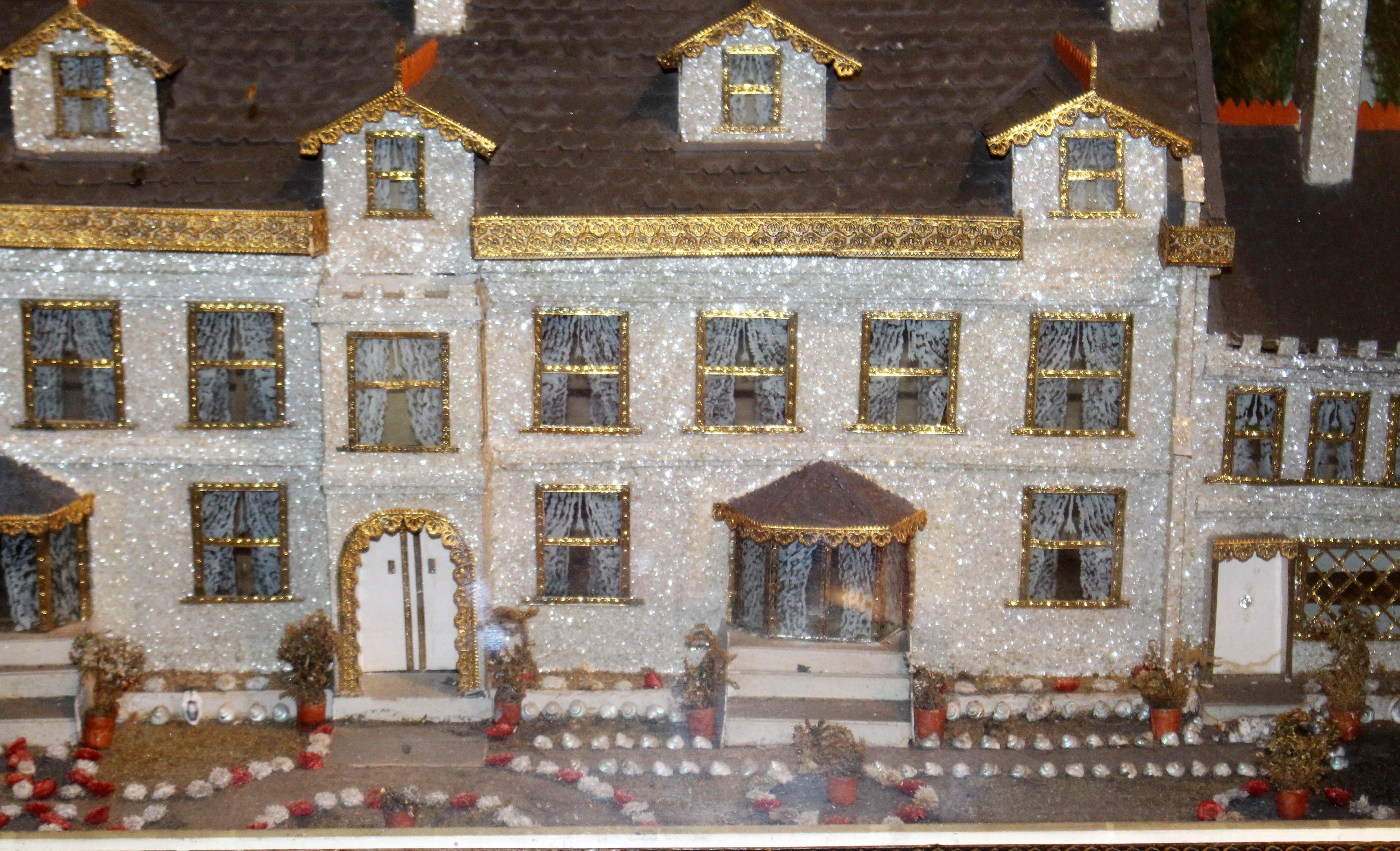 A wonderful c. 1860 English diorama of Stanfield Hall, even the original case & glass in outstanding condition. Note the wonderful use of shells, dried flowers & grasses for landscaping. Faux bois covering.
34 3/4