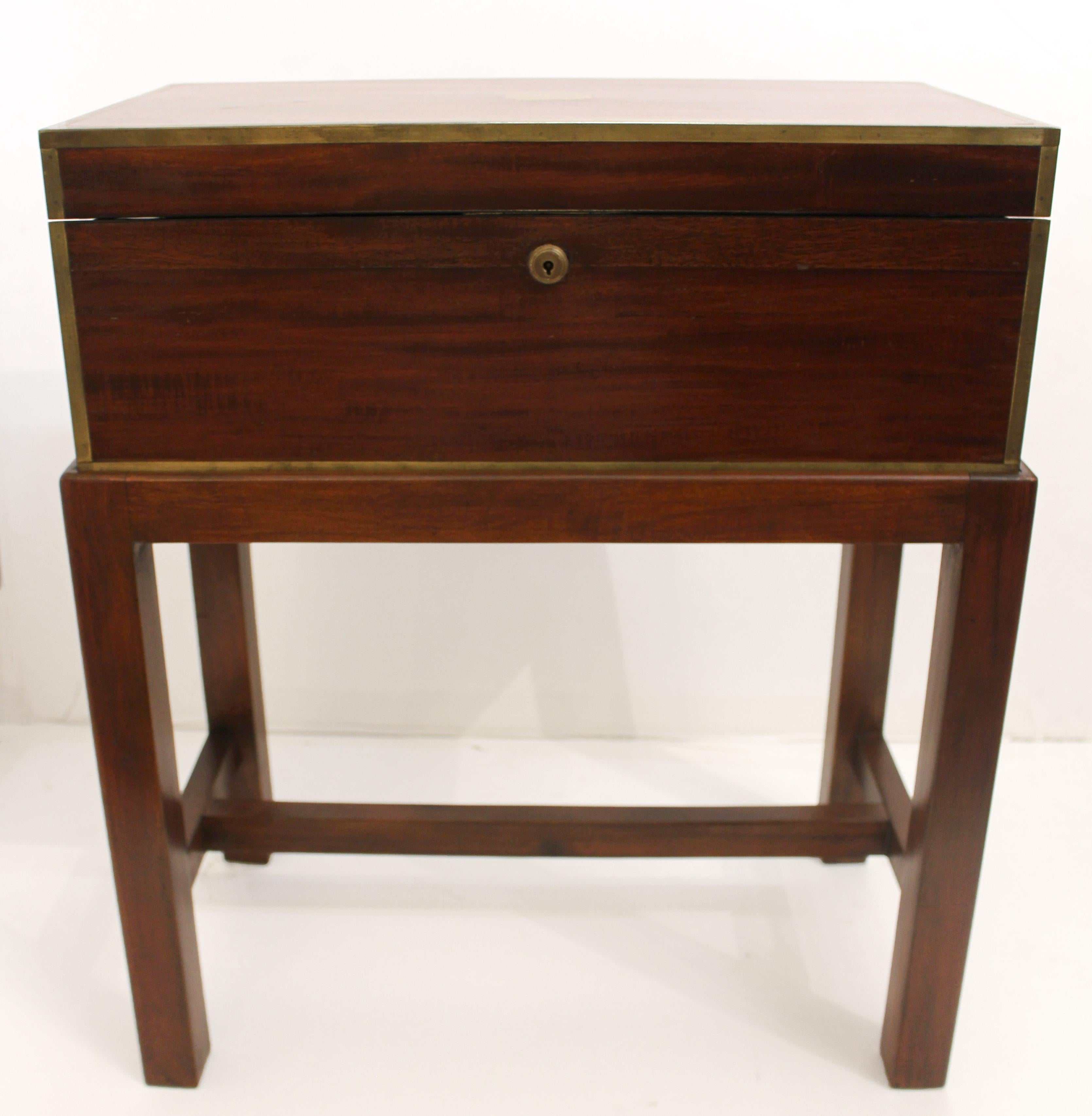 Circa 1860 lap desk now on custom made side table stand, English. Campaign lap desk of rosewood with fully marked Bramah lock. Full brass edging, monogram cartouche & inset flat handles. Velvet lined writing slope. Nicely fitted coromandel veneered