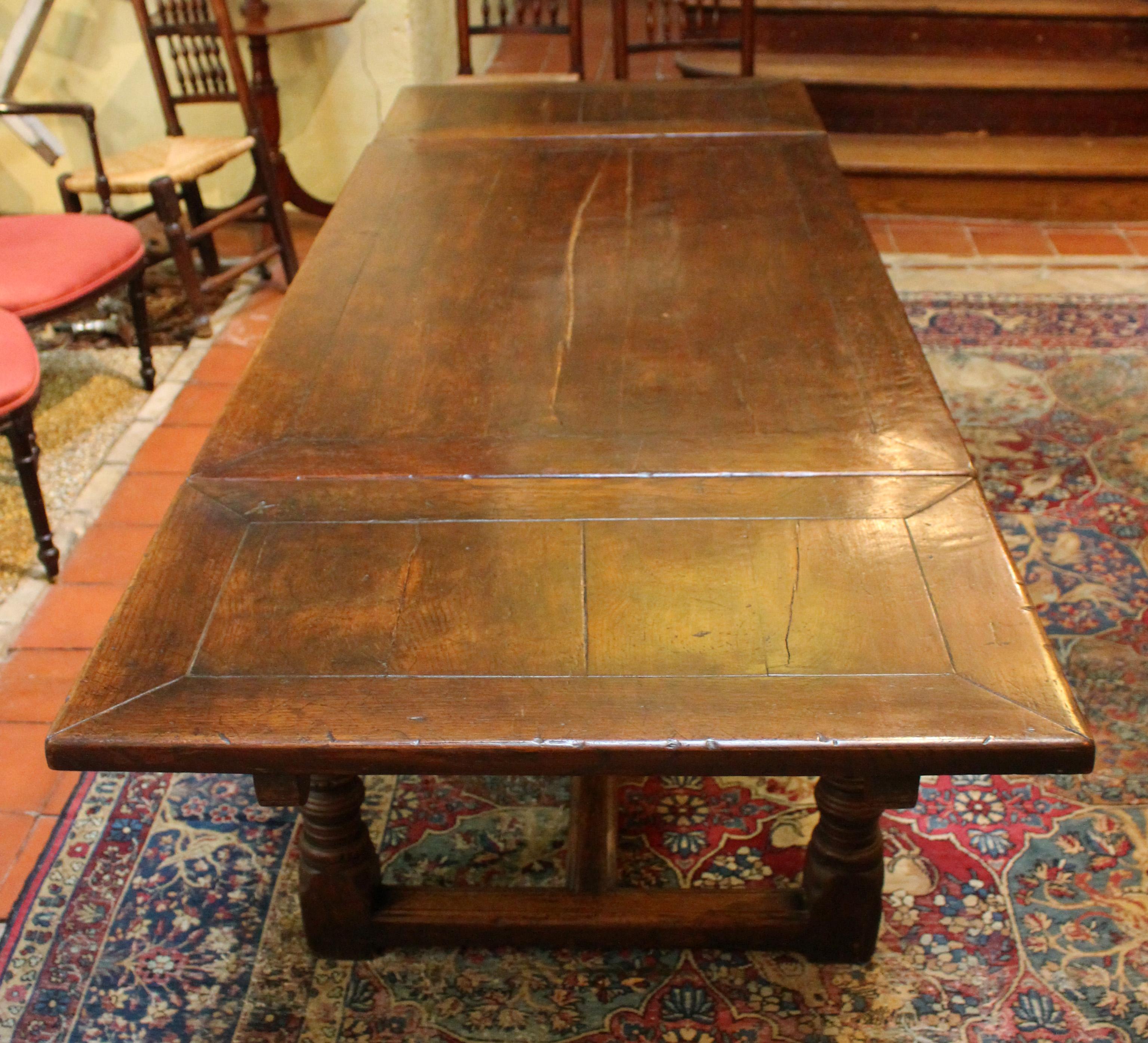 Circa 1860 Jacobean revival style draw leaf table, English. Oak. Solid form with chunky tops, h-stretcher & robust ring & vasi form carved legs.
31 3/4