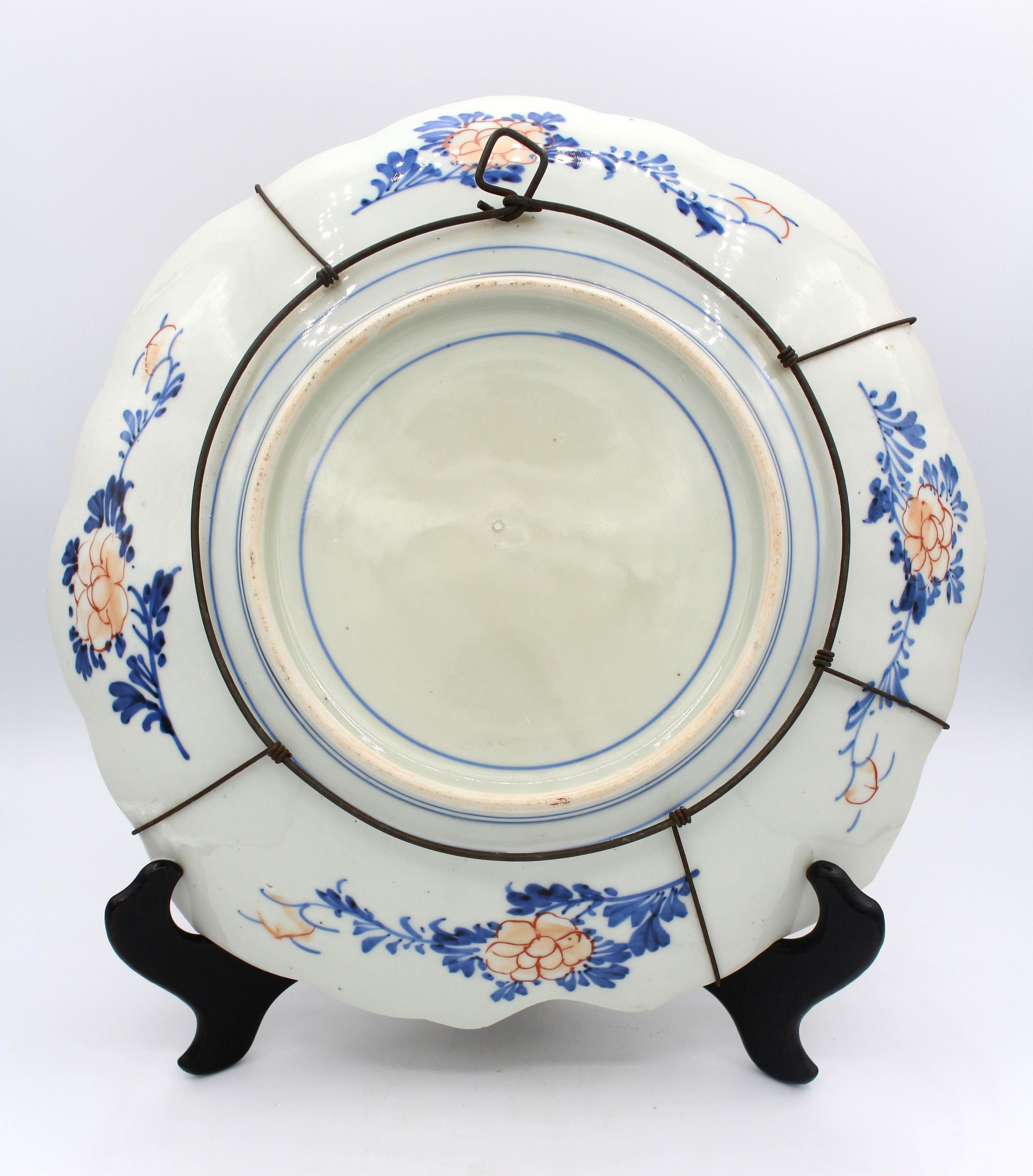 Circa 1860 lozenge shaped Imari Charger. Quadruple quadrants with alternating birds in landscape & naturalistic motifs, surrounding a central medallion of a tea table in garden. Reverse well decorated. Two minute & one tiny chip on reverse