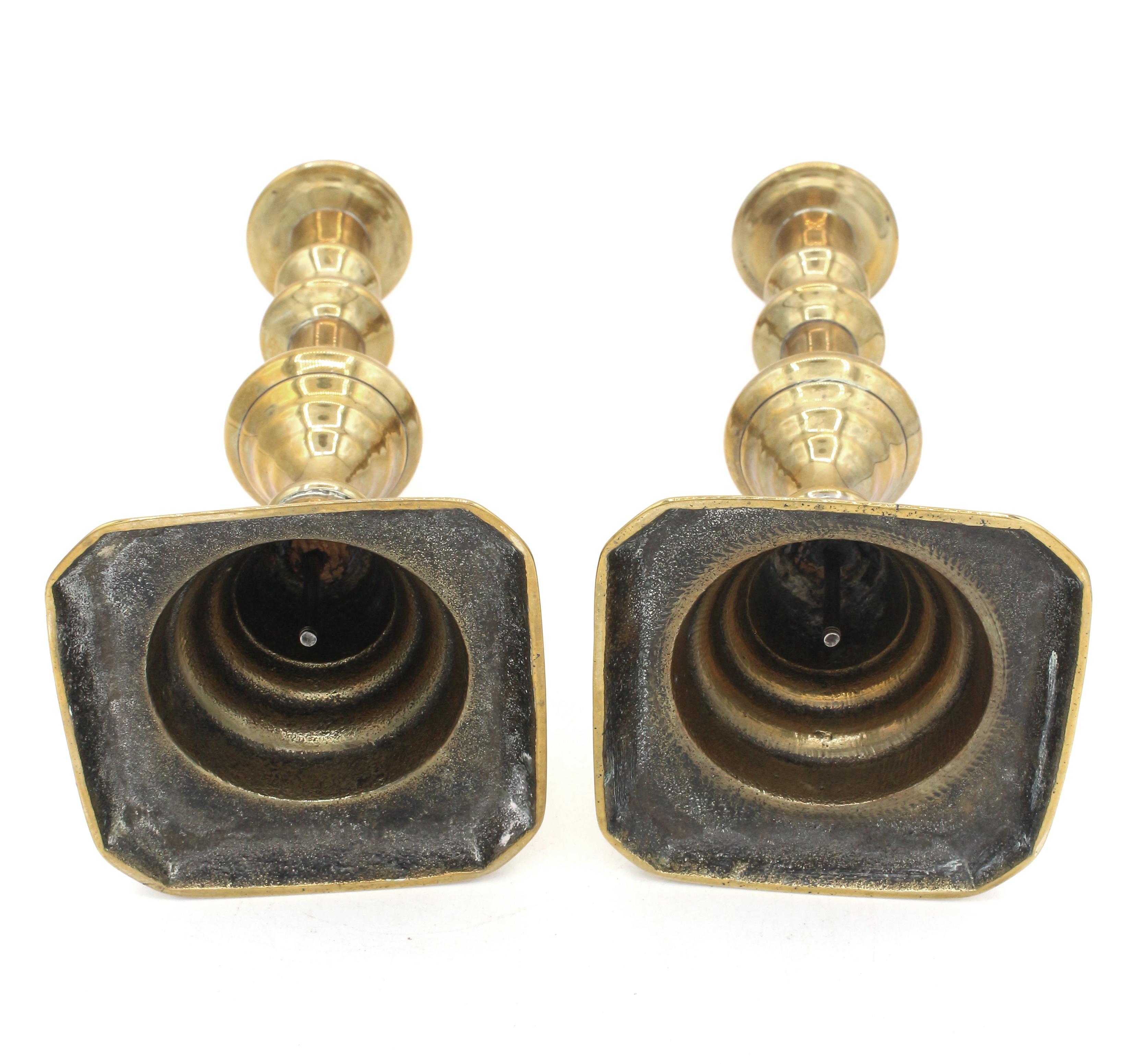 Circa 1860 pair of brass push-rod candlesticks, English. Inverted beehive design. Lack push-discs. Square, cut-corner bases.
9.75