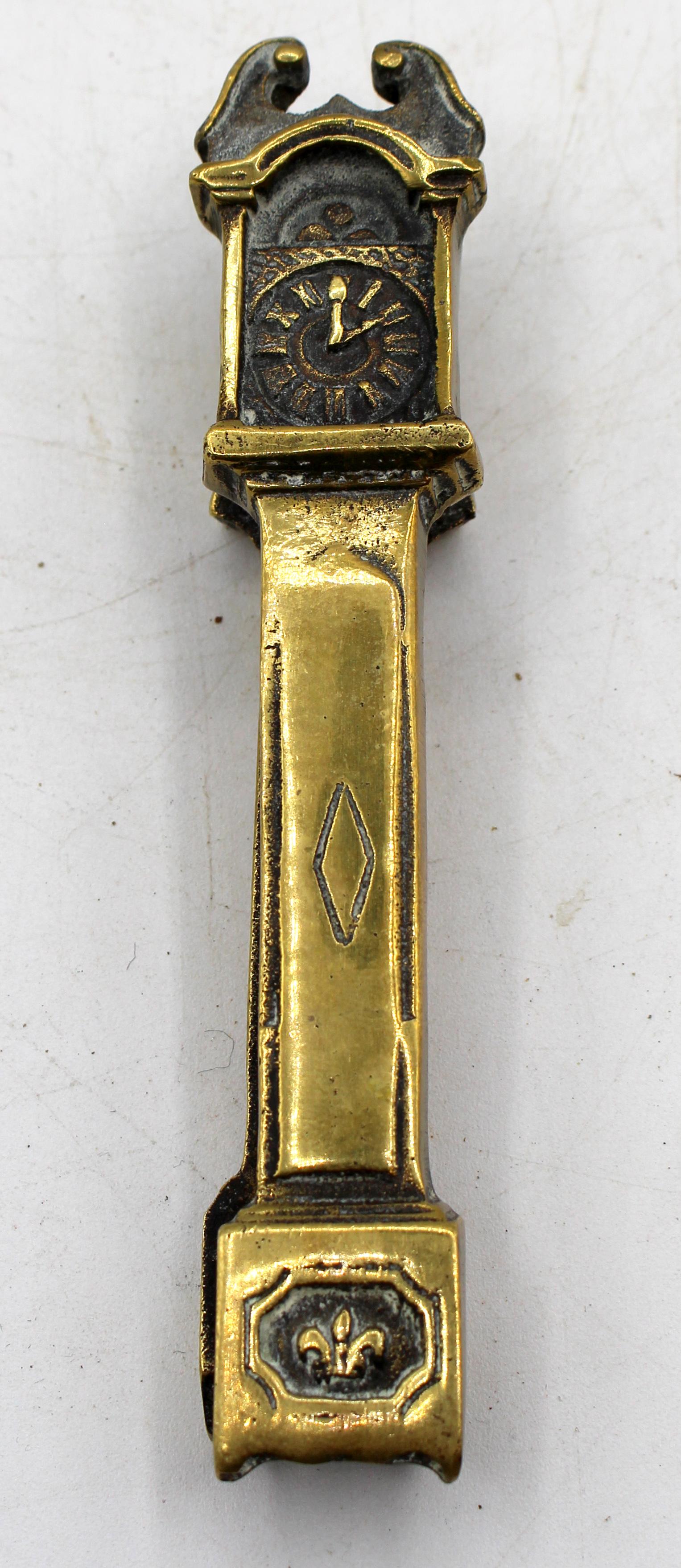 Circa 1860 period brass tall case clock form nutcracker, English. Victorian period. An unusual form for a nutcracker - a broken arch pediment tall case cloth. The upper part of the 