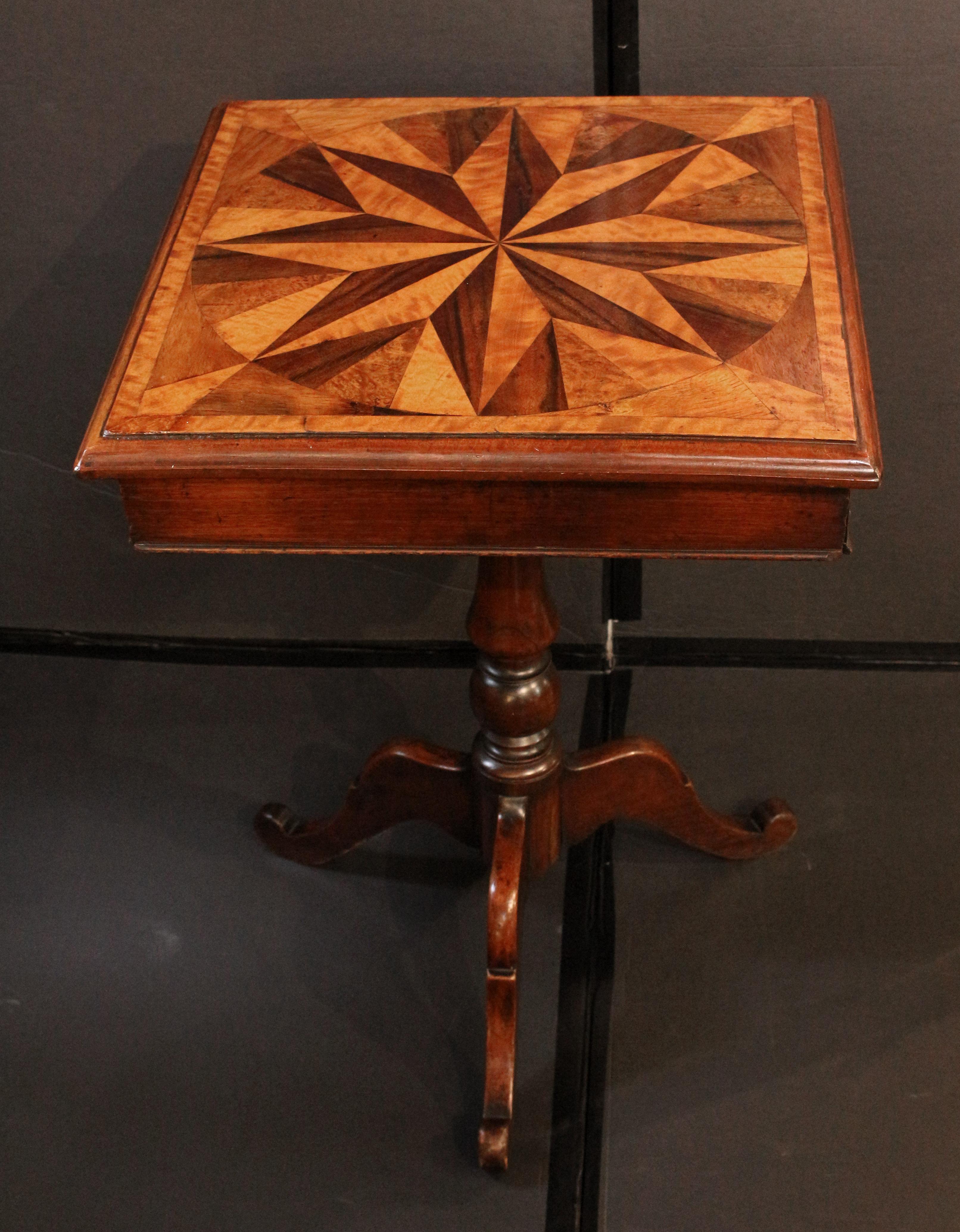 Circa 1860 star inlaid top side table with drawer, English. Specimen wood inlaid top. Hidden apron drawer. Mahogany with oak secondary. Turned pedestal base with 3 outswept, shaped legs.
19 1/4