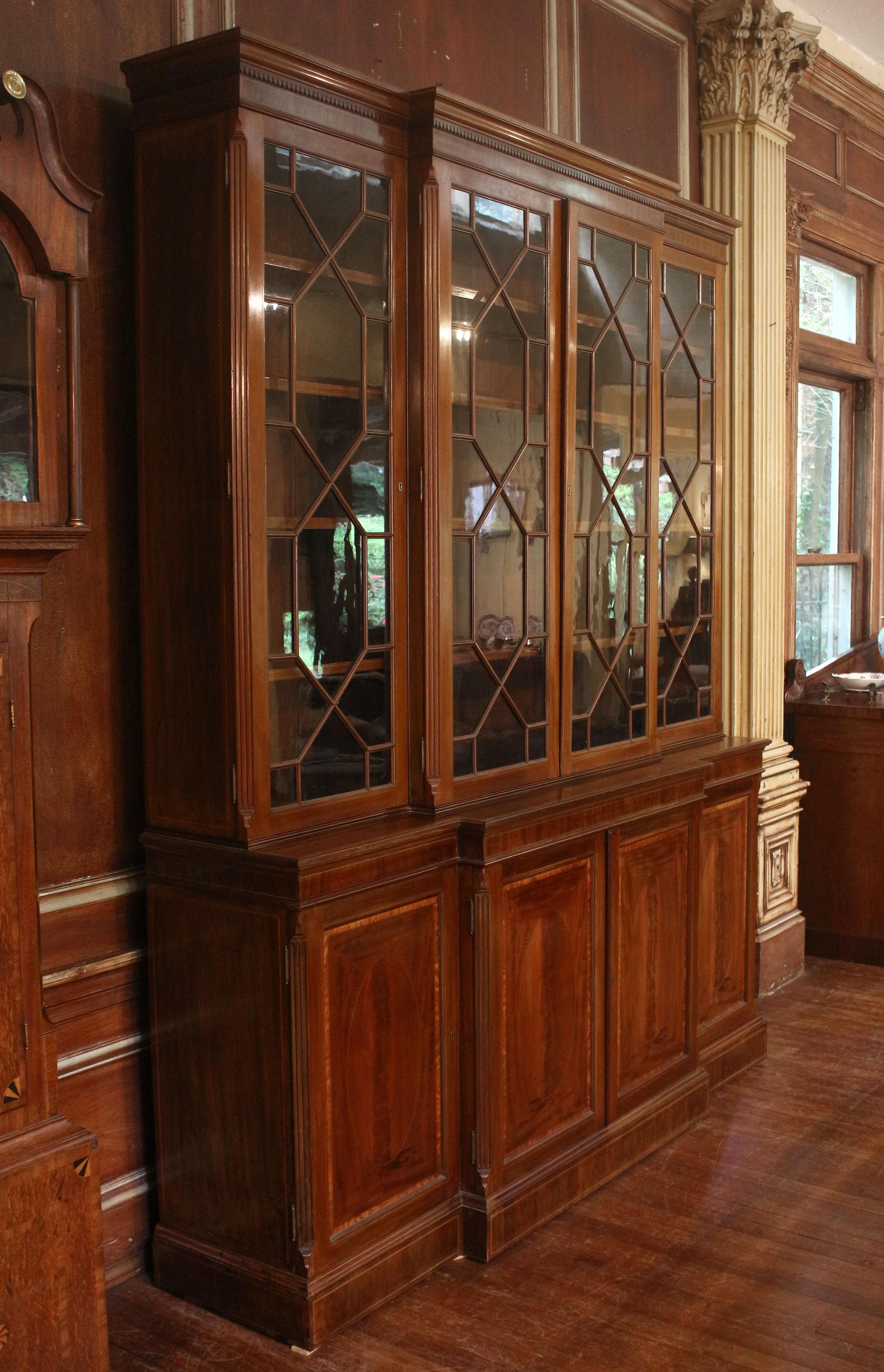 Circa 1860s Sheraton revival English breakfront bookcase cabinet. Mahogany. Stately proportions & exceptional quality. From a country house in Sussex, it displays the expected fine details of design and construction. Note how the molding on crown