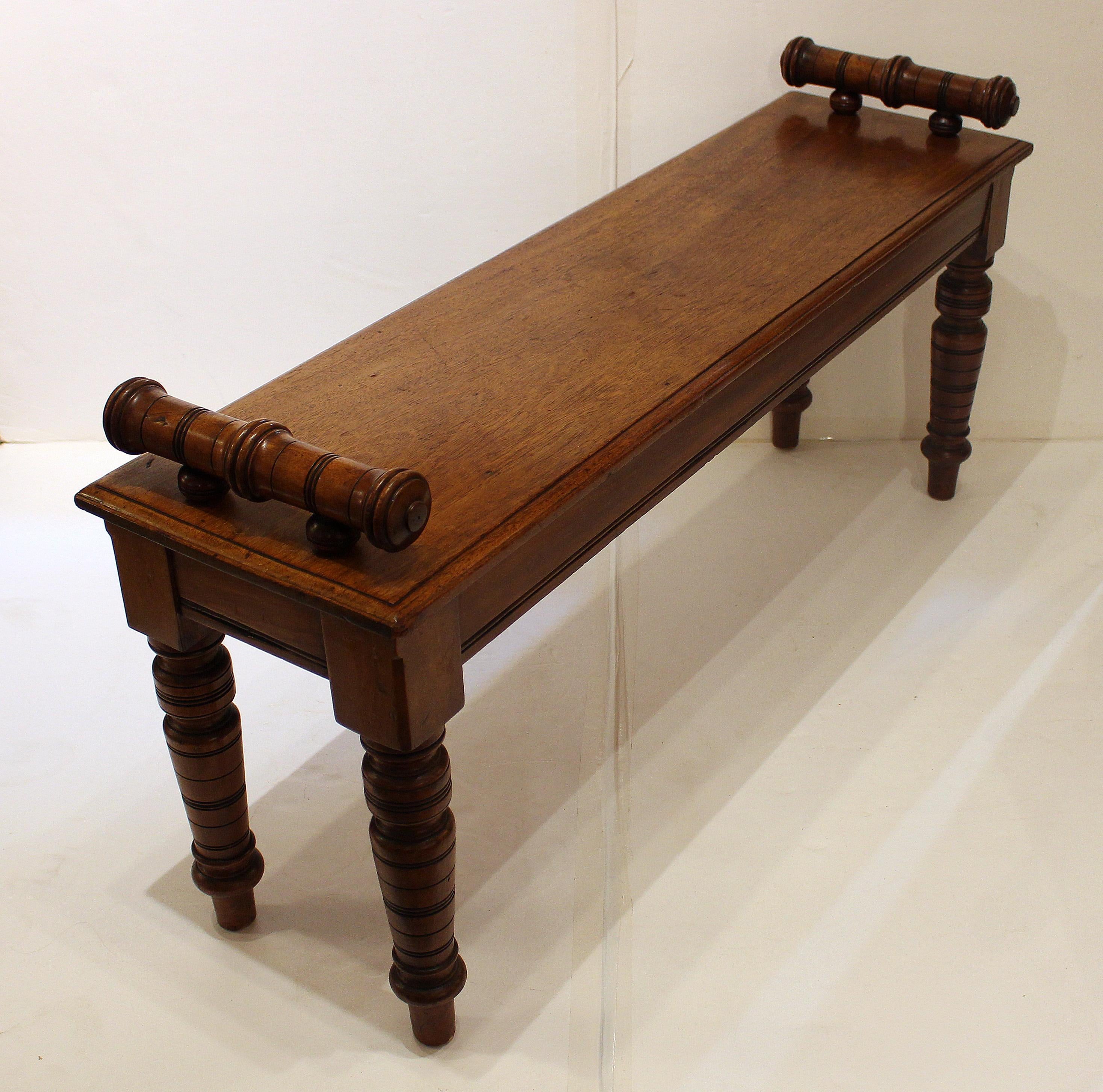 Hall or window bench, English. Boldly turned, tapered legs, circa 1865. Raised, ring turned bolsters. Fine color. Aprons of thick mahogany over deal. Seat & turnings of solid mahogany. Provenance: Estate of Katharine Reid, former director Cleveland