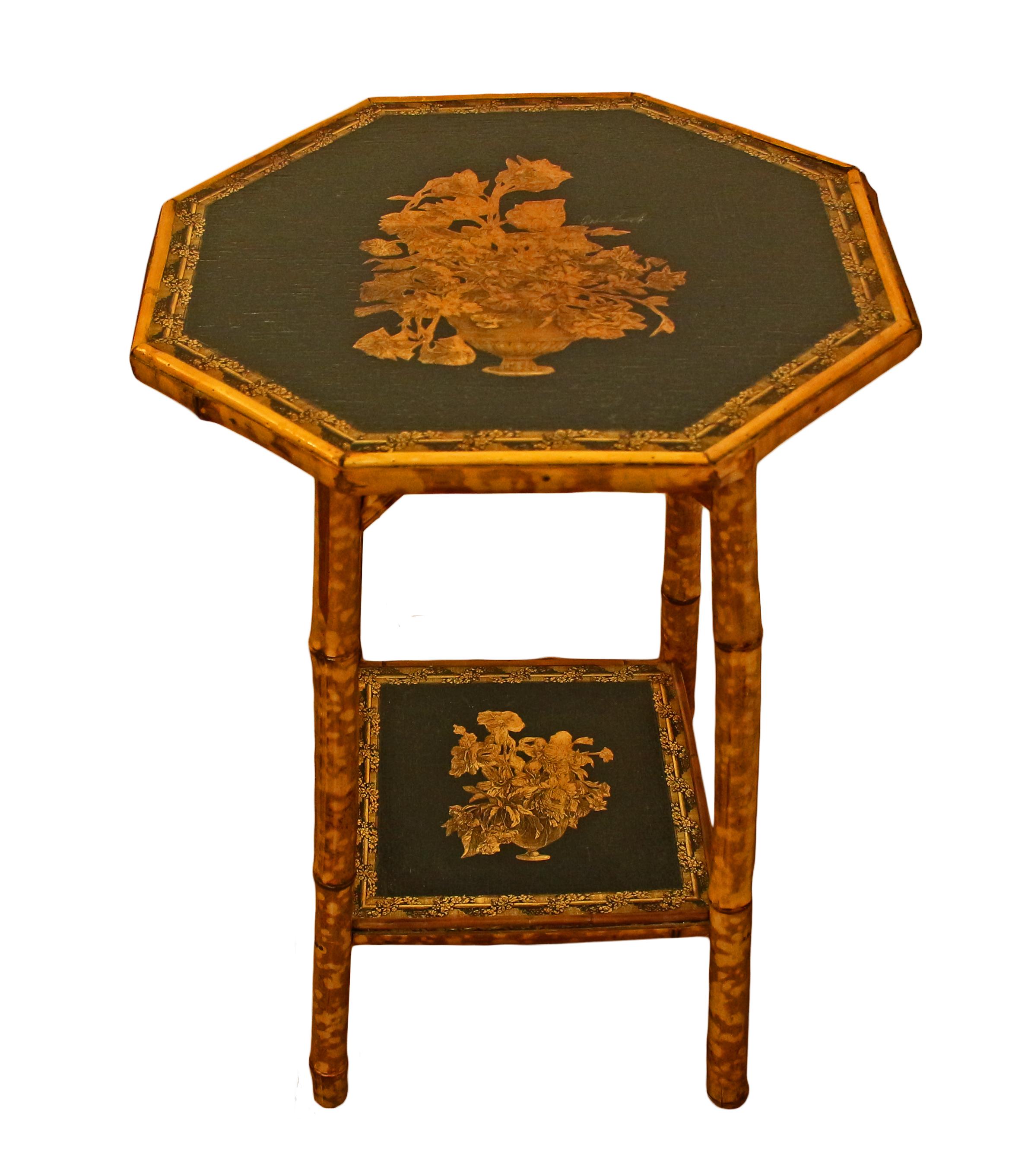 Octagonal 2-tier bamboo side table, English, circa 1870. Well figured bamboo. Straight legs with upper architectural strut supports. Newly decoupaged with a vase of flowers & botanical garland border. Measures: 18 1/4