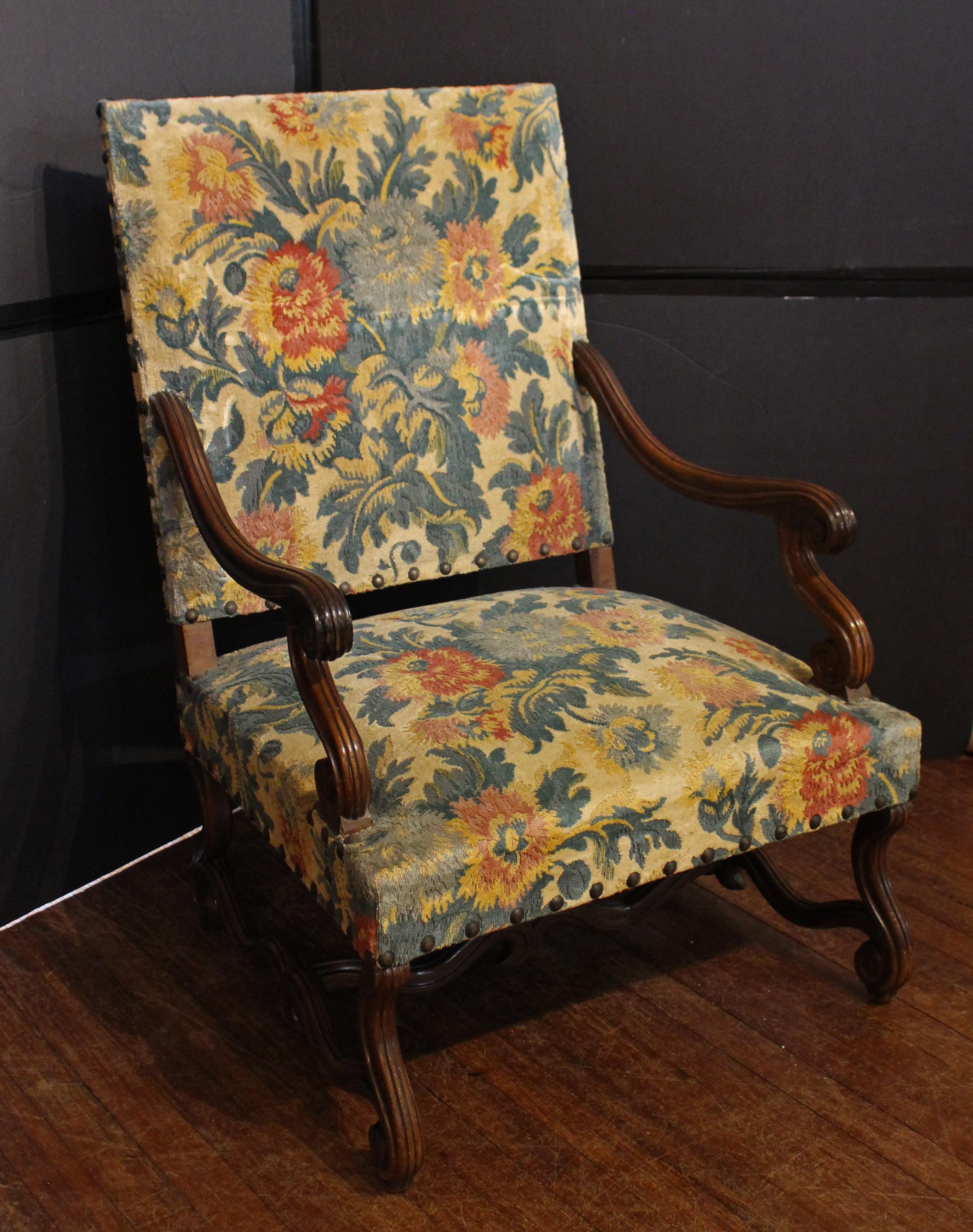 Circa 1870 grand scale Regence style fauteuil, French. Walnut. Well molded throughout, S-scroll arms & legs, with shaped stretcher base. Wonderful old as found French upholstery. 27 3/4