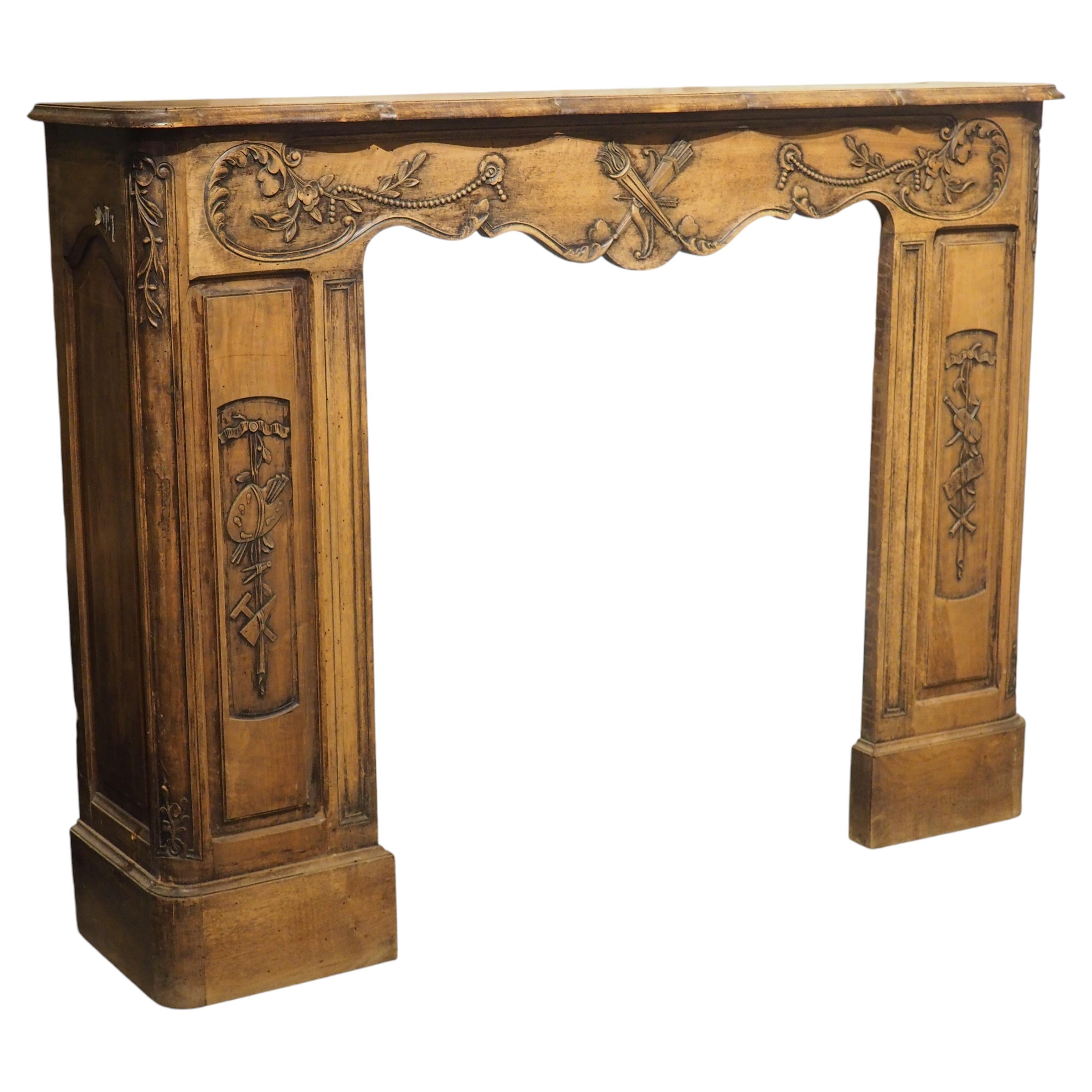 Circa 1870 French Walnut Fireplace Mantel with Trophies of Music and the Arts