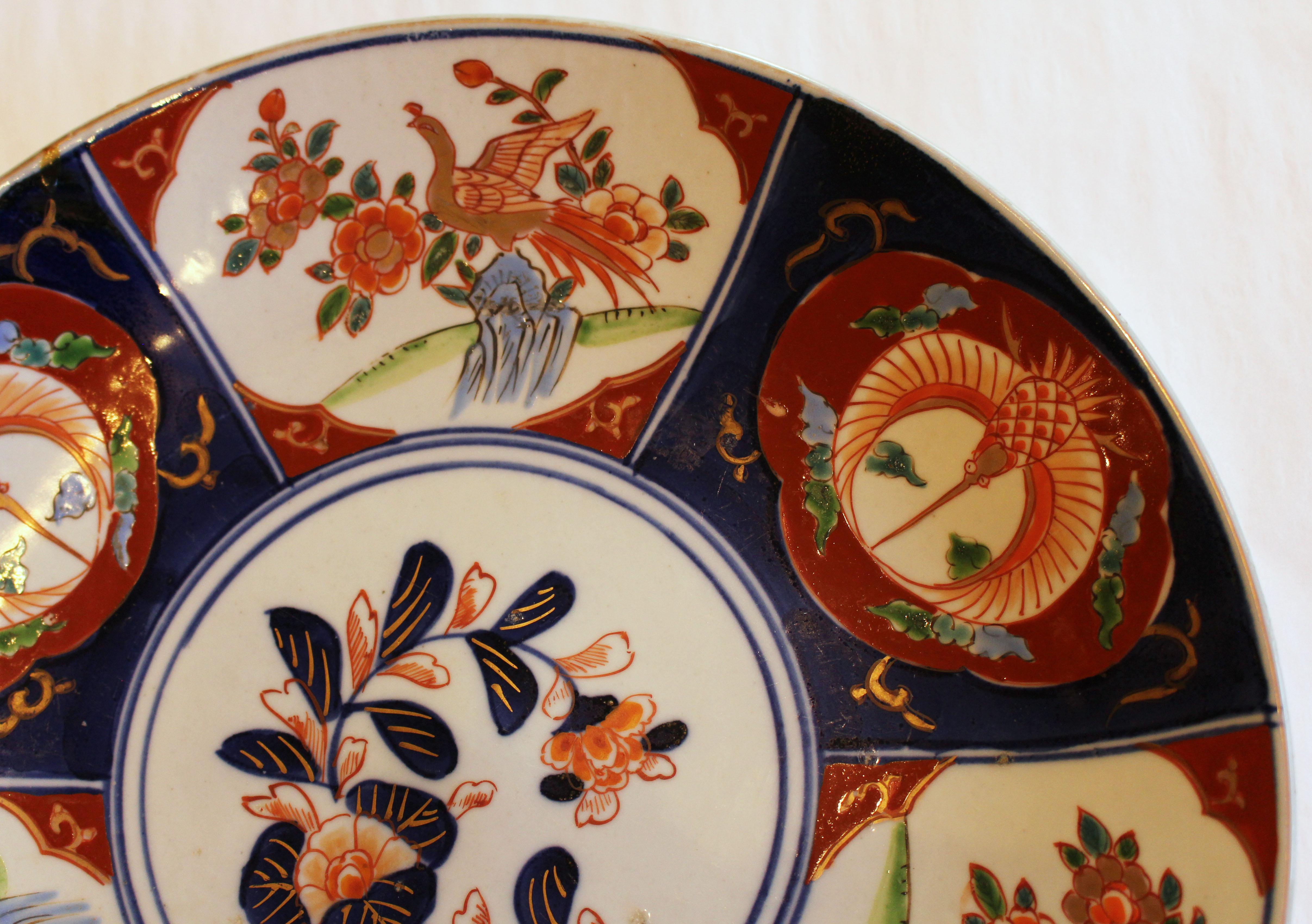 An Imari chop plate. Charming, well decorated panels featuring phoenix birds around a central floral medallion. Japan, c.1870. Minor kiln flaw and glaze flaw.
12