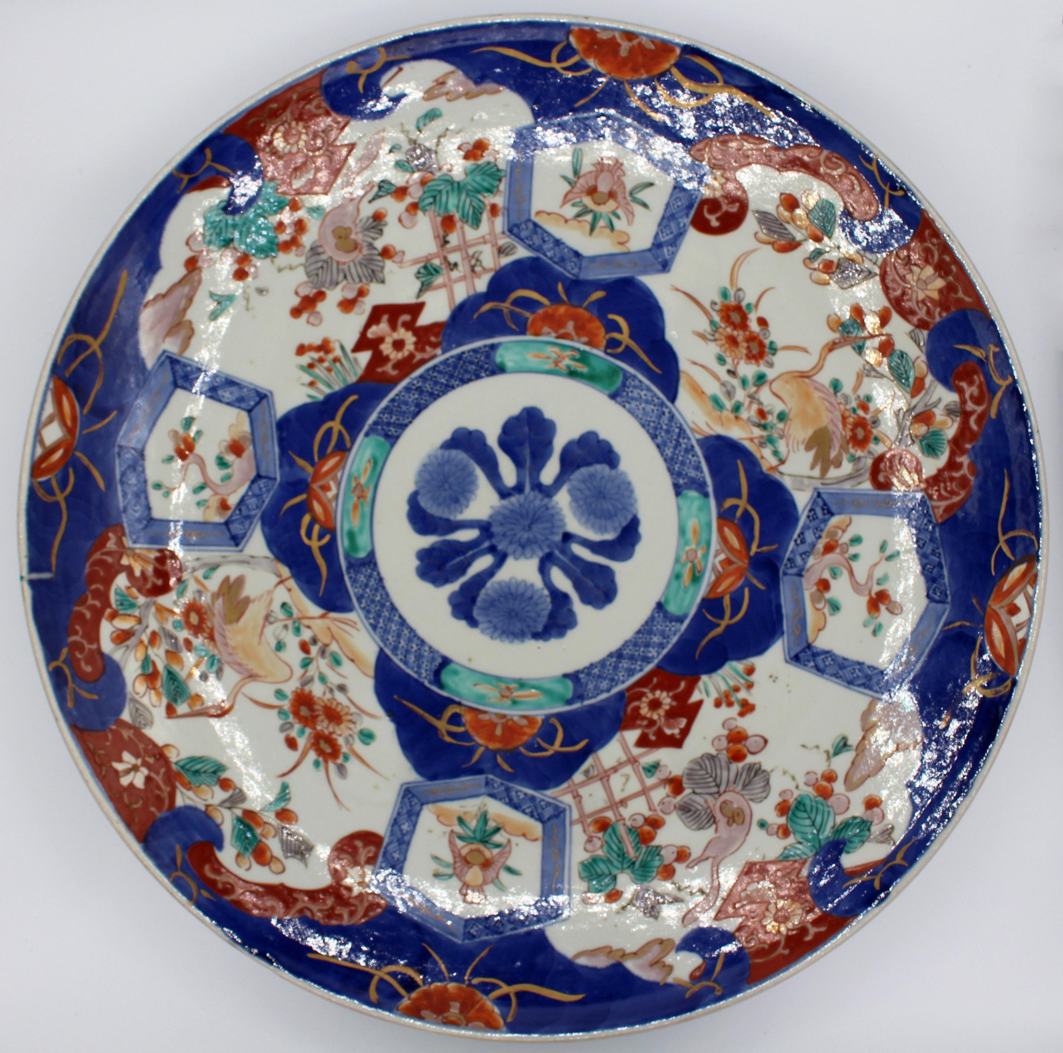 Circa 1870 large Imari charger. Well decorated with 4 alternating panels of the red-crowned crane or Tancho walking through foliage and bamboo lattice garden set off by 4 lozenges with birds & branches, around a central medallion. The turquoise