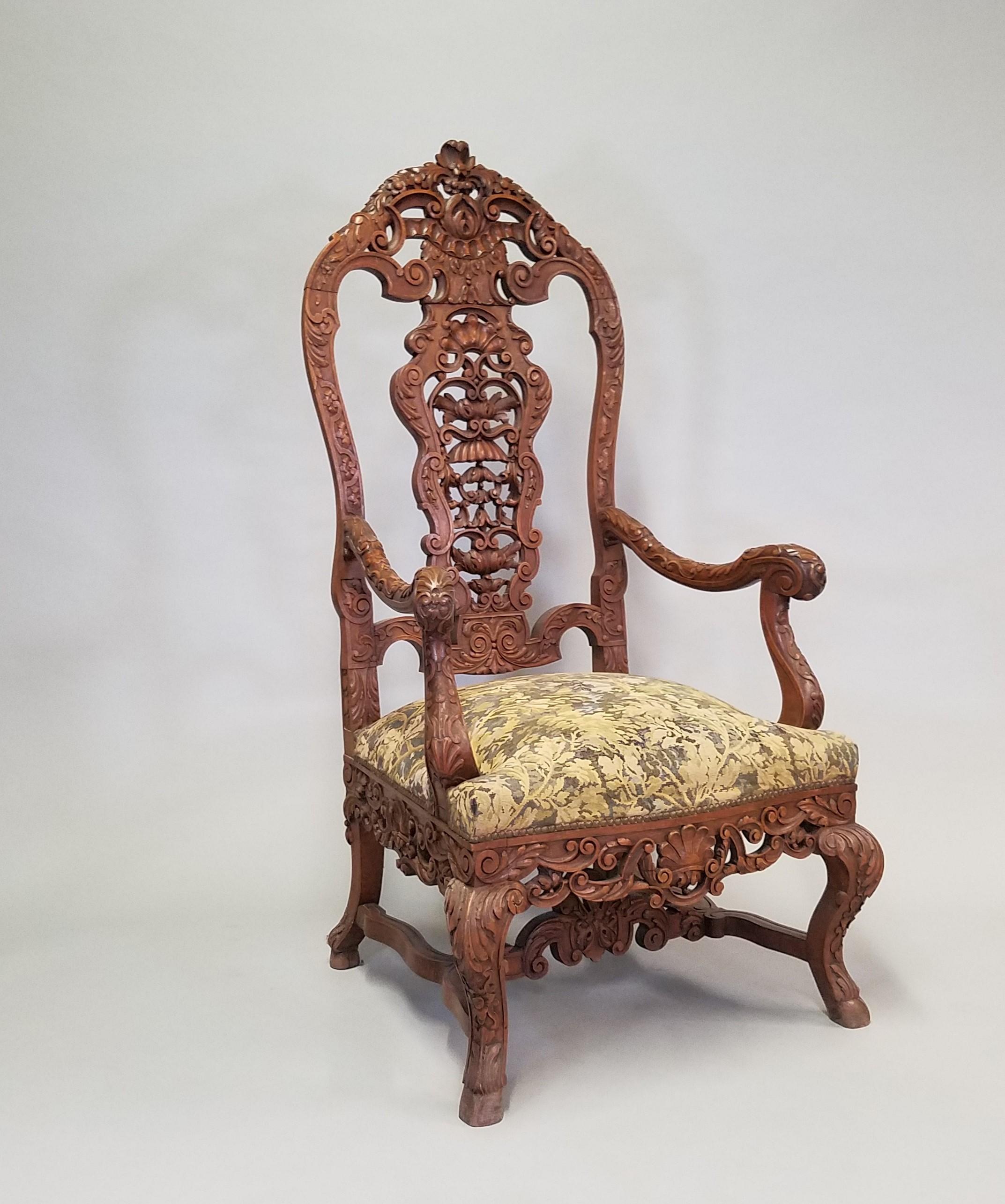 Pair of Circa 1870 Louis XV Renaissance Style Walnut Armchairs. These marvelous chairs feature high carved backs with intricate hand-carved ornamentation of interlaced foliage and anthemion leaves. The splendid cross stretchers intertwine