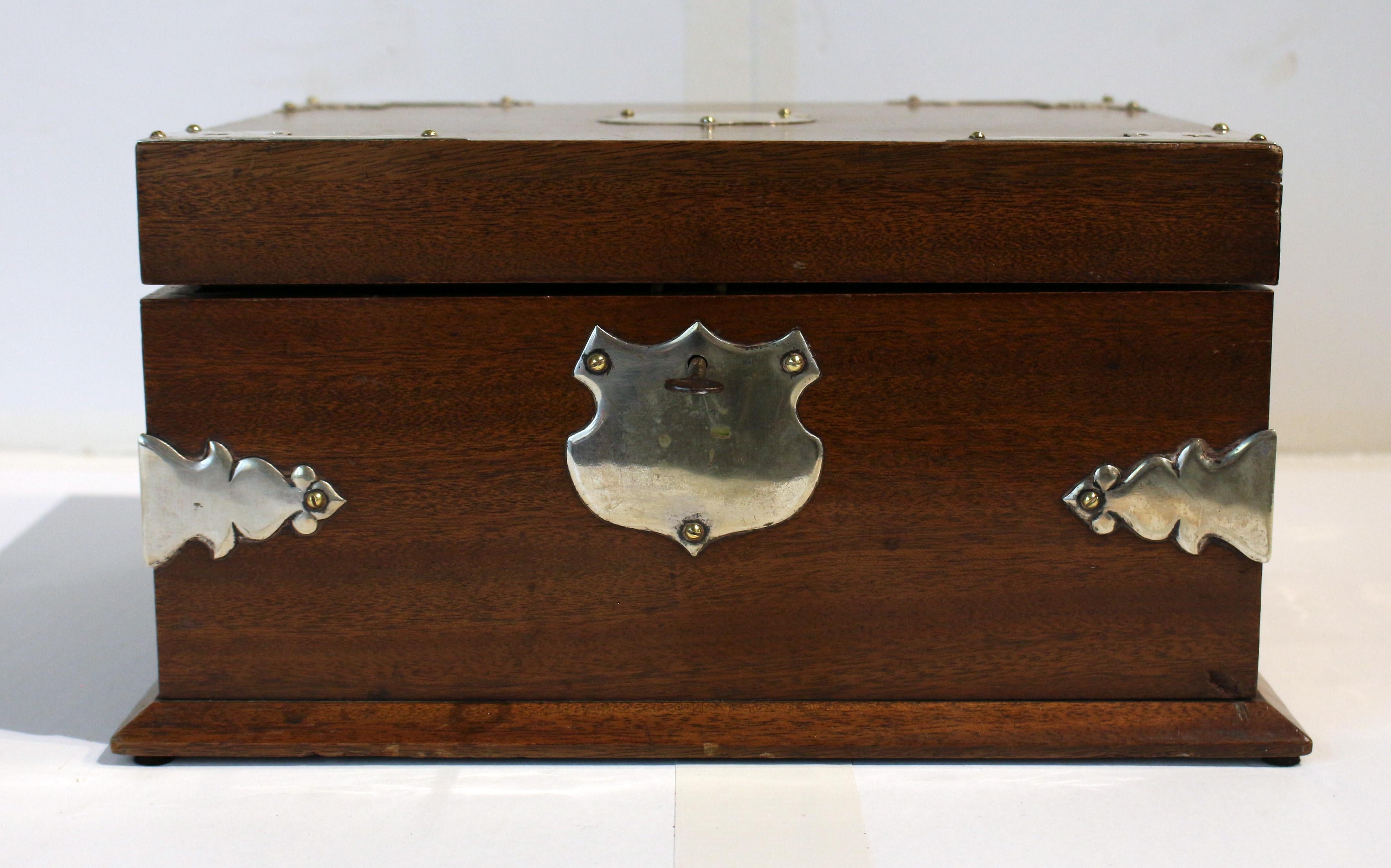 Circa 1870s humidor box with silverplated mounts, English. Mahogany. Shield escutcheon & central mount, corner mounts & cut work backplate handles. 13 1/8