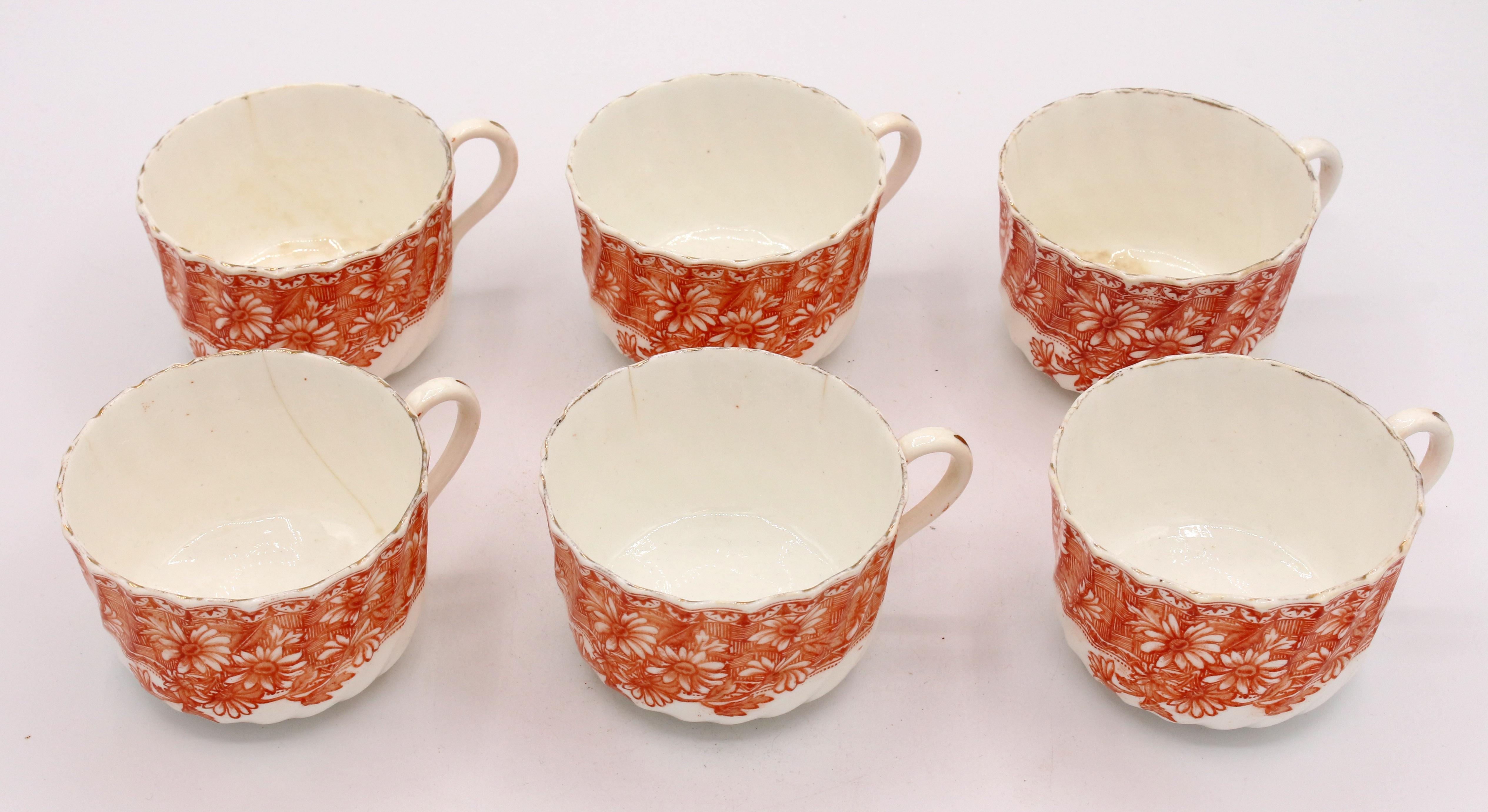 An English china orange decor tea & cake service for 6, circa 1880-1900, transfer printed in a Japonisme motif. 6 cups & saucers, 6 cake plates & a pair of serving plates. Tea stains & kiln flaws.
8 3/8