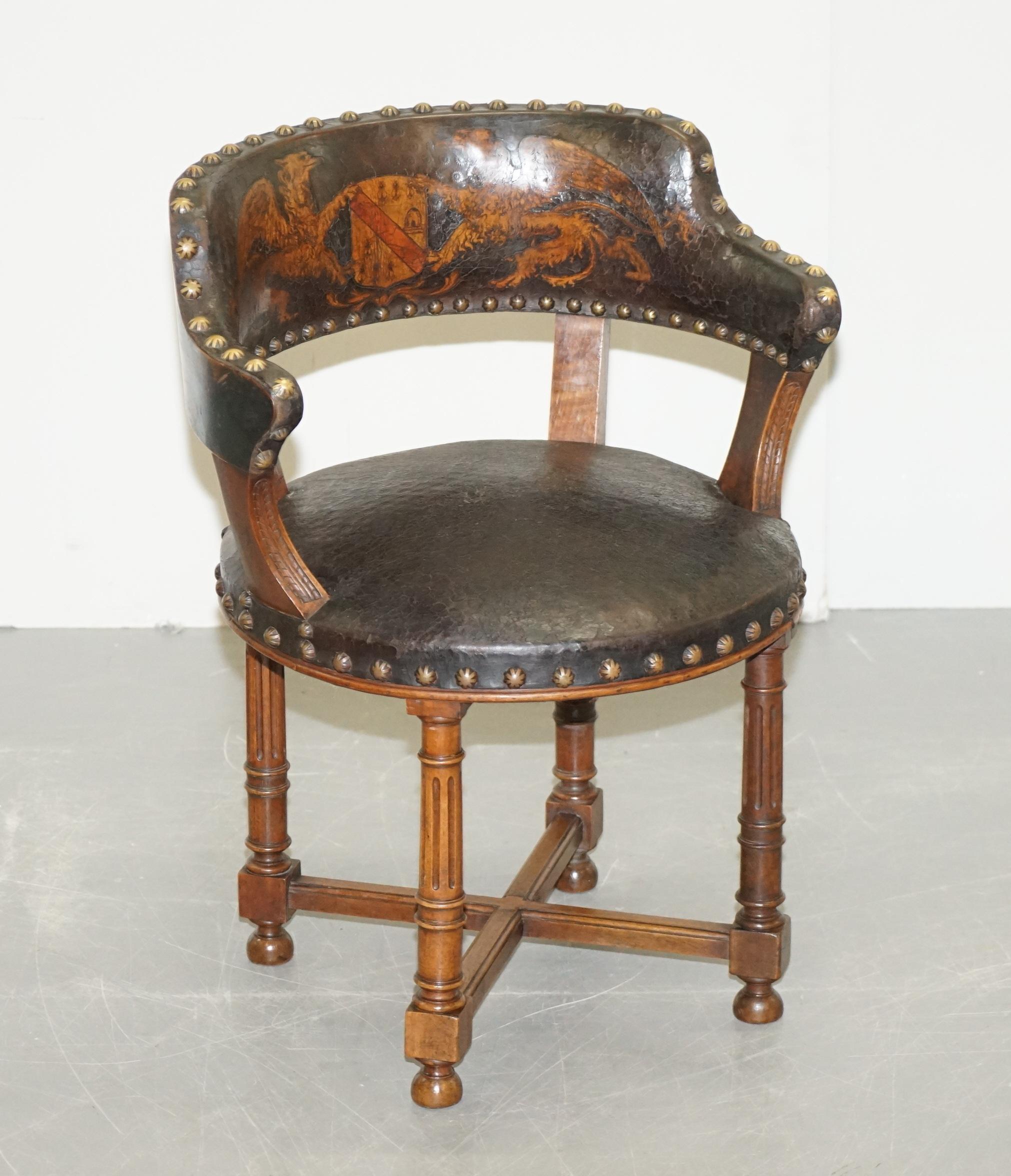 Wimbledon-Furniture

Wimbledon-Furniture is delighted to offer for sale this absolutely exquisite circa 1880 Victorian walnut framed with embossed brown leather upholstery captain’s chair with armorial crest coat of arms depicting Griffons holding