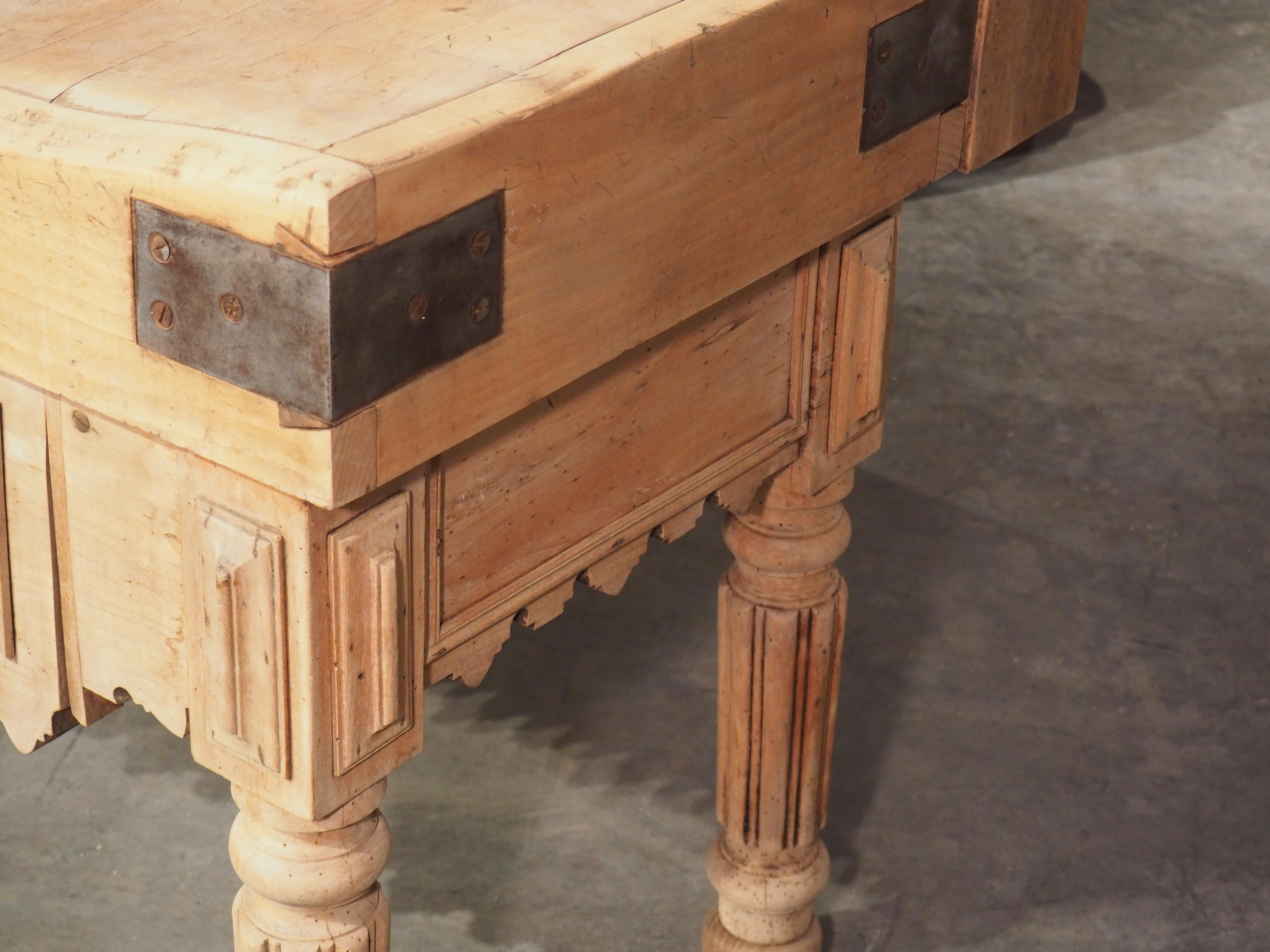 Manufactured in Lille, France, circa 1880, this wood butcher block features a well-used, square parquetry top. The billot (as it is known in France) would have been used in a butcher shop to cut and tenderize meat for customers; the bend you see to
