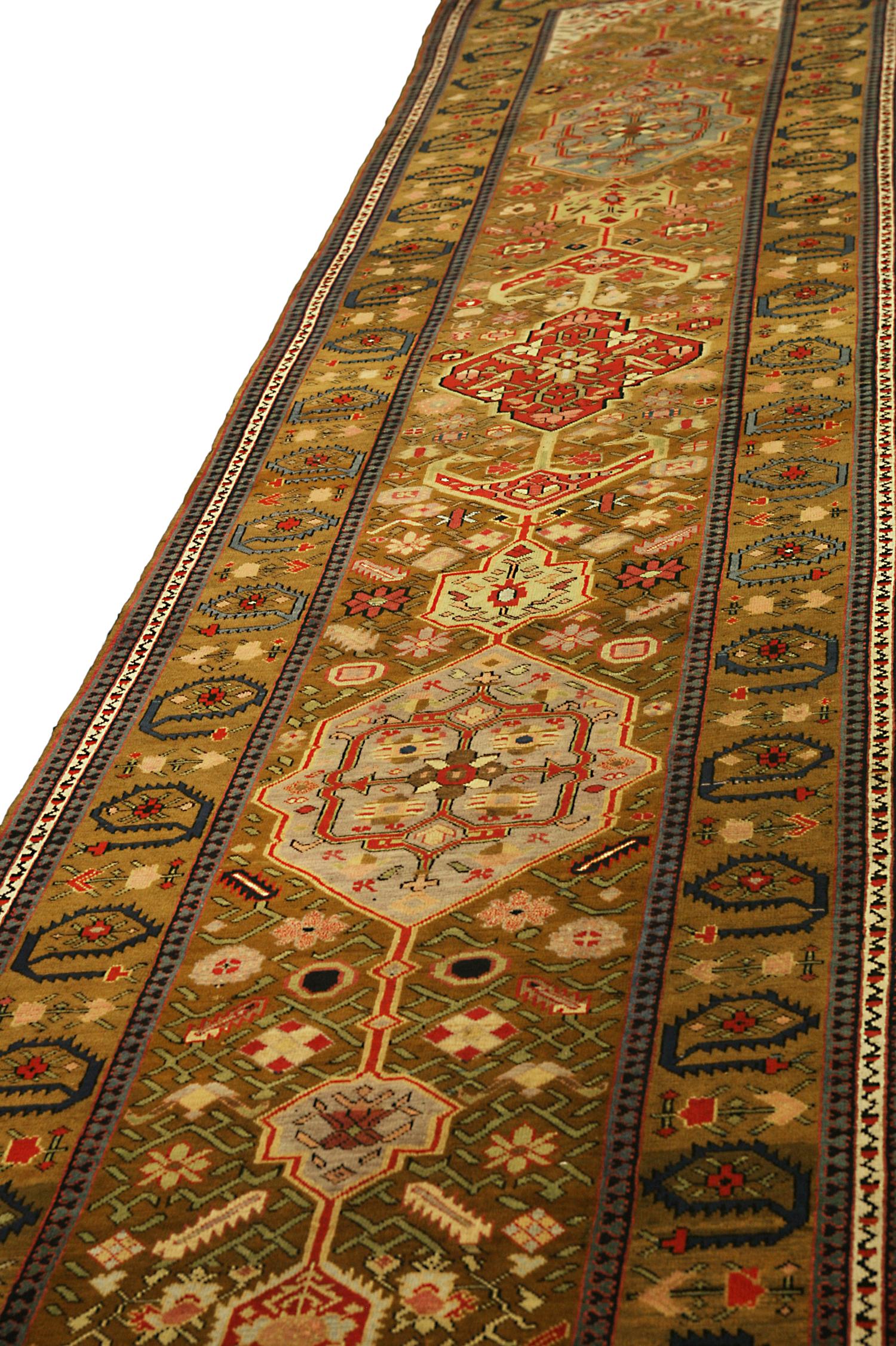This is an antique Karabagh runner rug woven circa 1880 which has a striking design at first sight. The dark brown of the background draws attention to floral motif designs in an intriguing way. Karabagh runners, like this antique carpet, are from