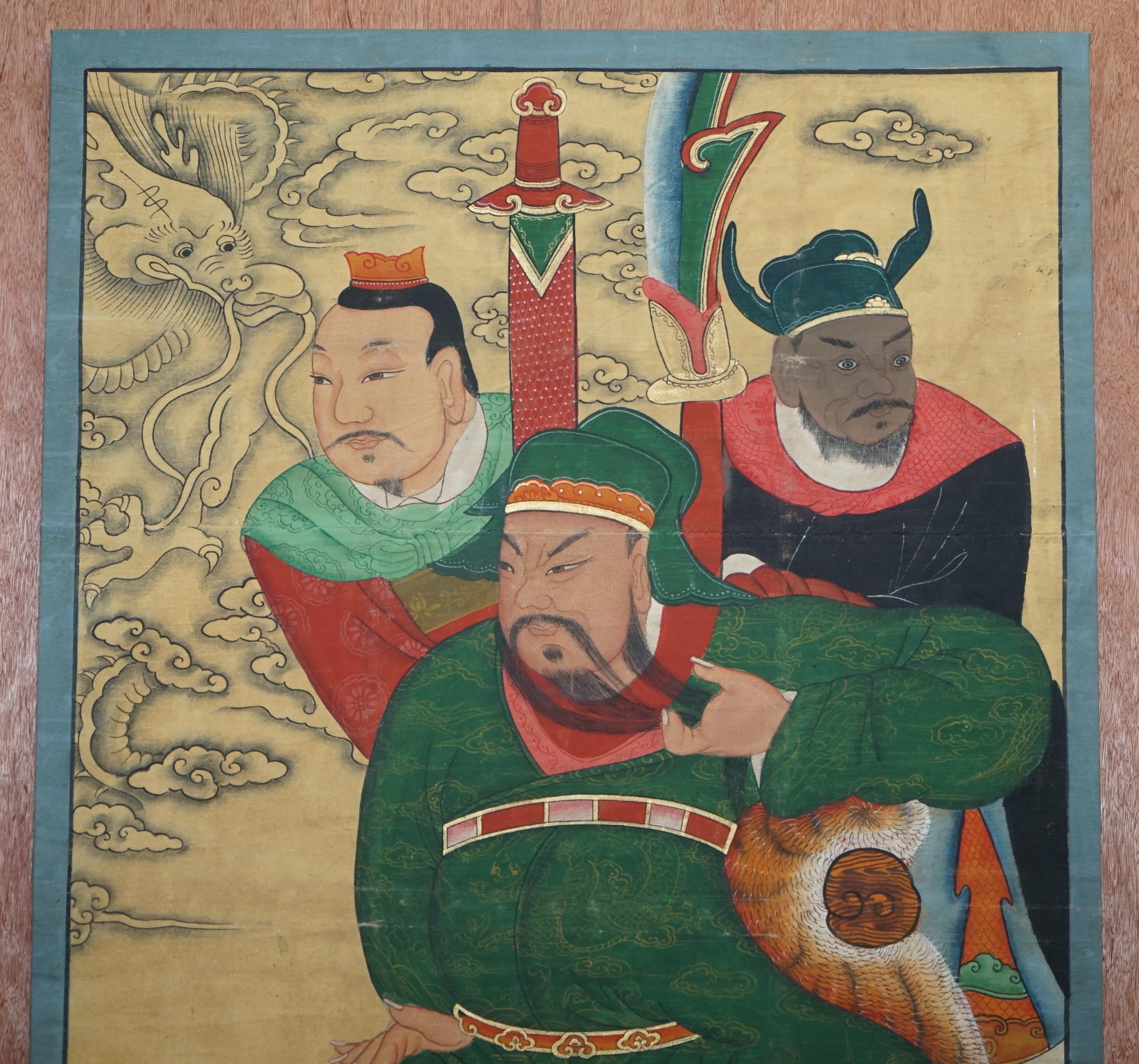 We are delighted to offer for sale this very rare Chinese ancestral Warrior oil on canvas painting which is part of a suite

The is the medium one, it depicts some kind of lord seated on a throne upholstered with tiger fur and two protective