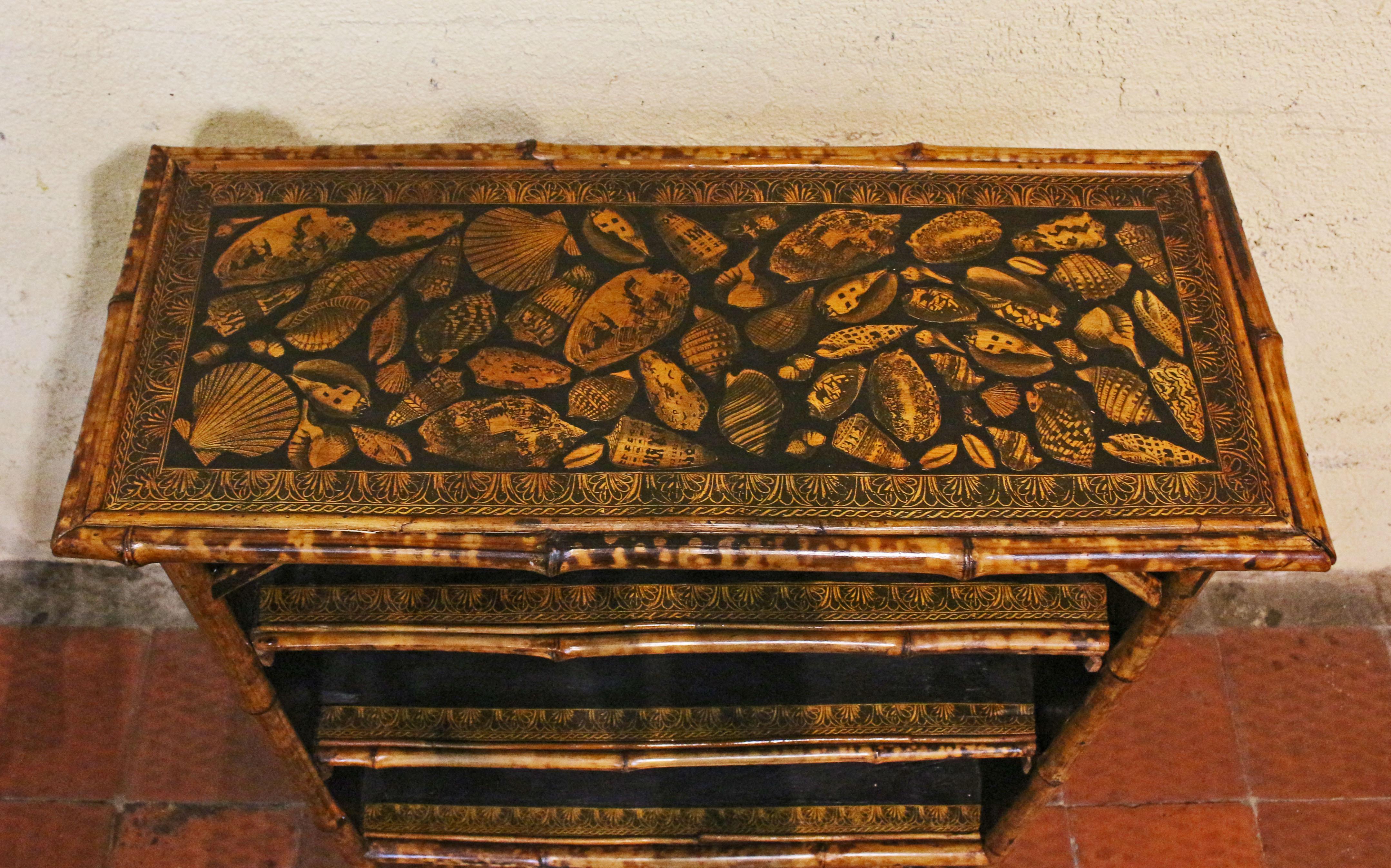 Circa 1880 English bamboo bookcase now artisan decoupaged with shells. Well figured 