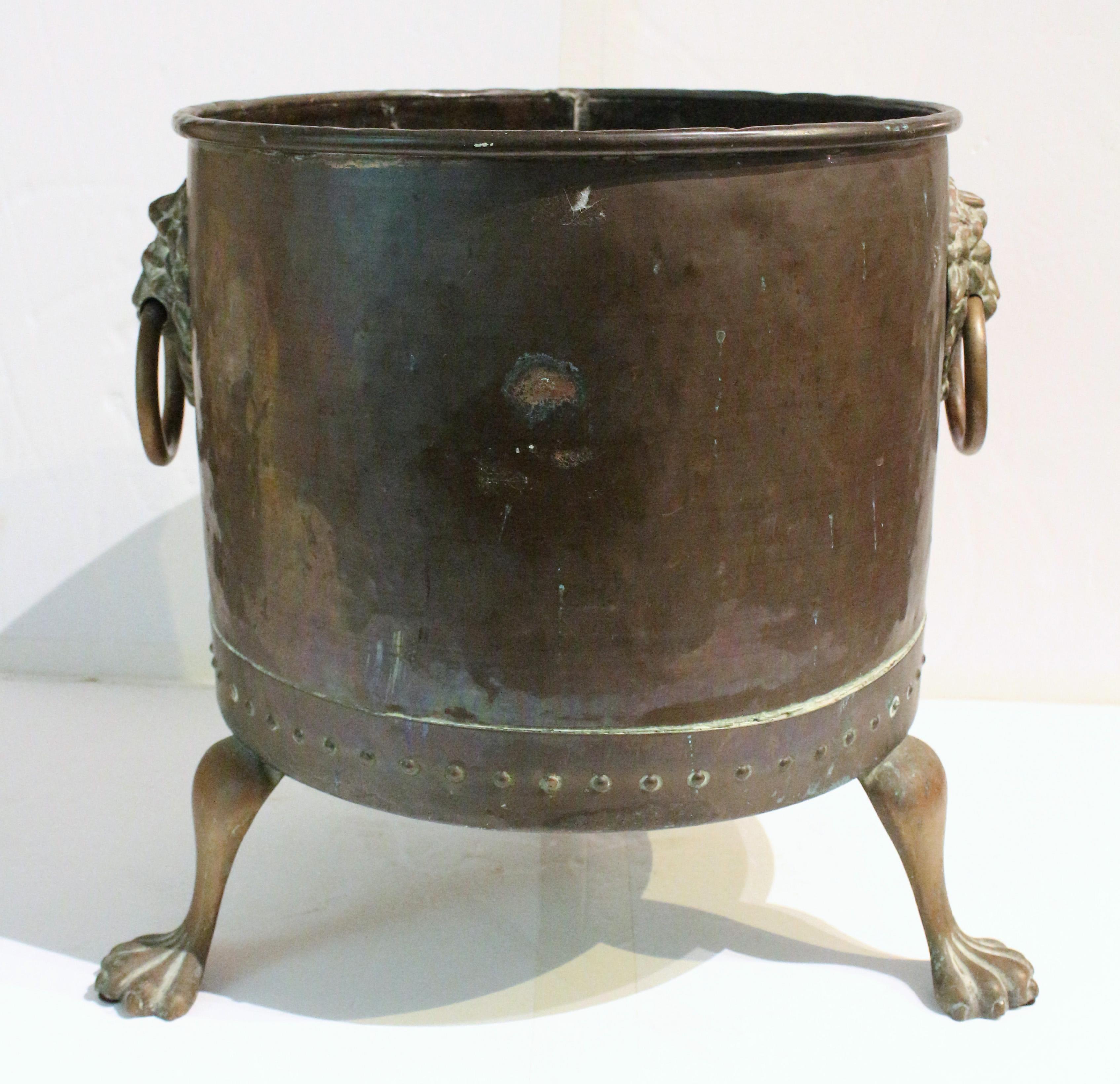 Circa 1880 round copper log bin on paw feet, English. Very well modelled lion masks with ring handles. Three shaped legs ending in paw feet. Condition commensurate with age & use.
16 1/4