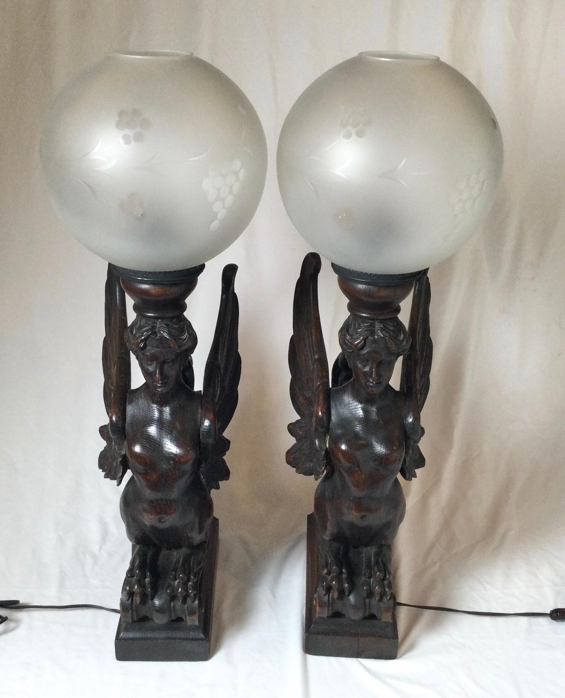 Circa 1880 pair of hand carved wood winged caryatids-griffins, now as table lamps
Architectural carvings from the Victorian age that have been electrified. 
Great for those that are looking for something unusual.
Dimensions: 13