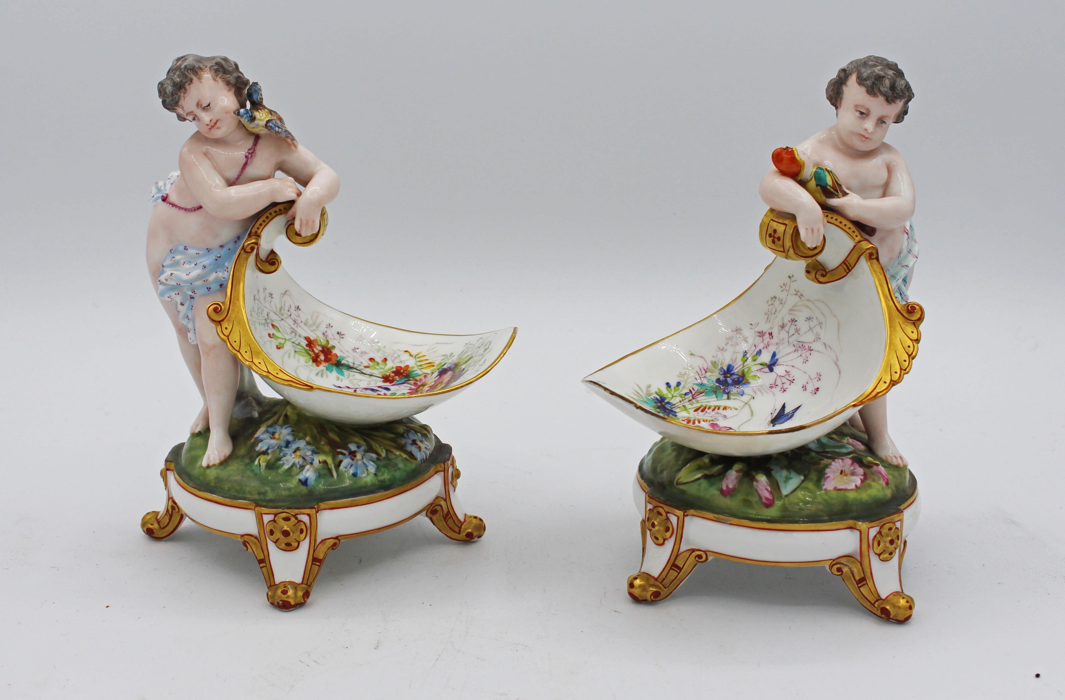 A charming pair of porcelain children figural potpourri stands, c.1880s. One child with toy soldier and one with a bird on her shoulder. English or Continental with indecipherable impressed marks. Superbly painted and gilded. One bowl has the front