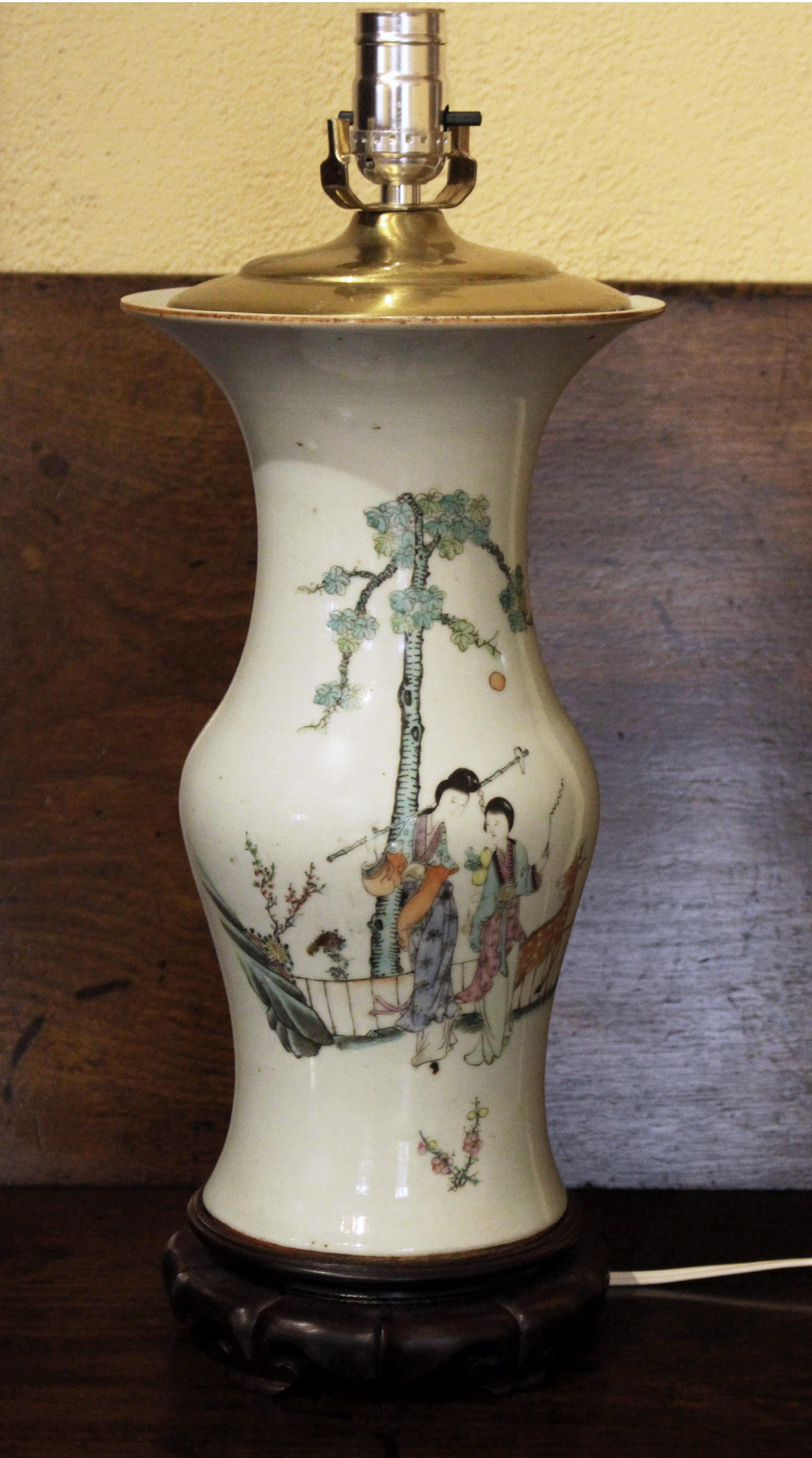 Circa 1880s Chinese export baluster form vase lamp. Late Qing dynasty. Light celadon ground. Elegant woman with a fawn under a pine tree. Old top of rim fleck. Spinach jade finial. Measures: 31
