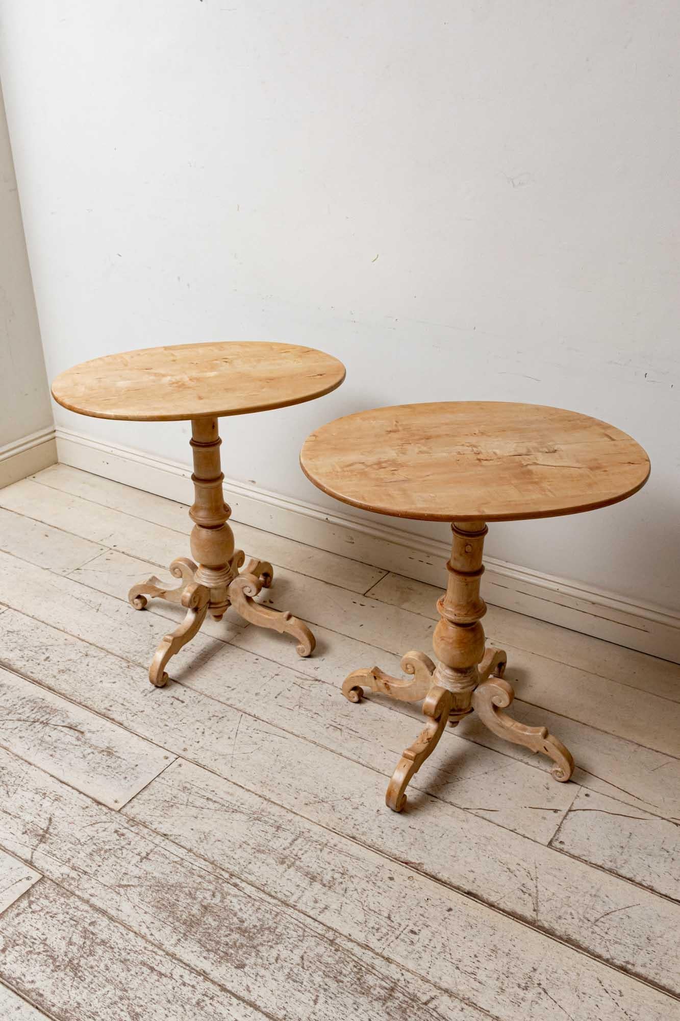 Fabulous pair of Swedish Birch side or sofa tables with lovely scrolled detail on each of the four-leggeds circa 19th century . The rounded oval tabletop sits on a turned baluster stem which sits on four scrolled splayed legs. The table has been