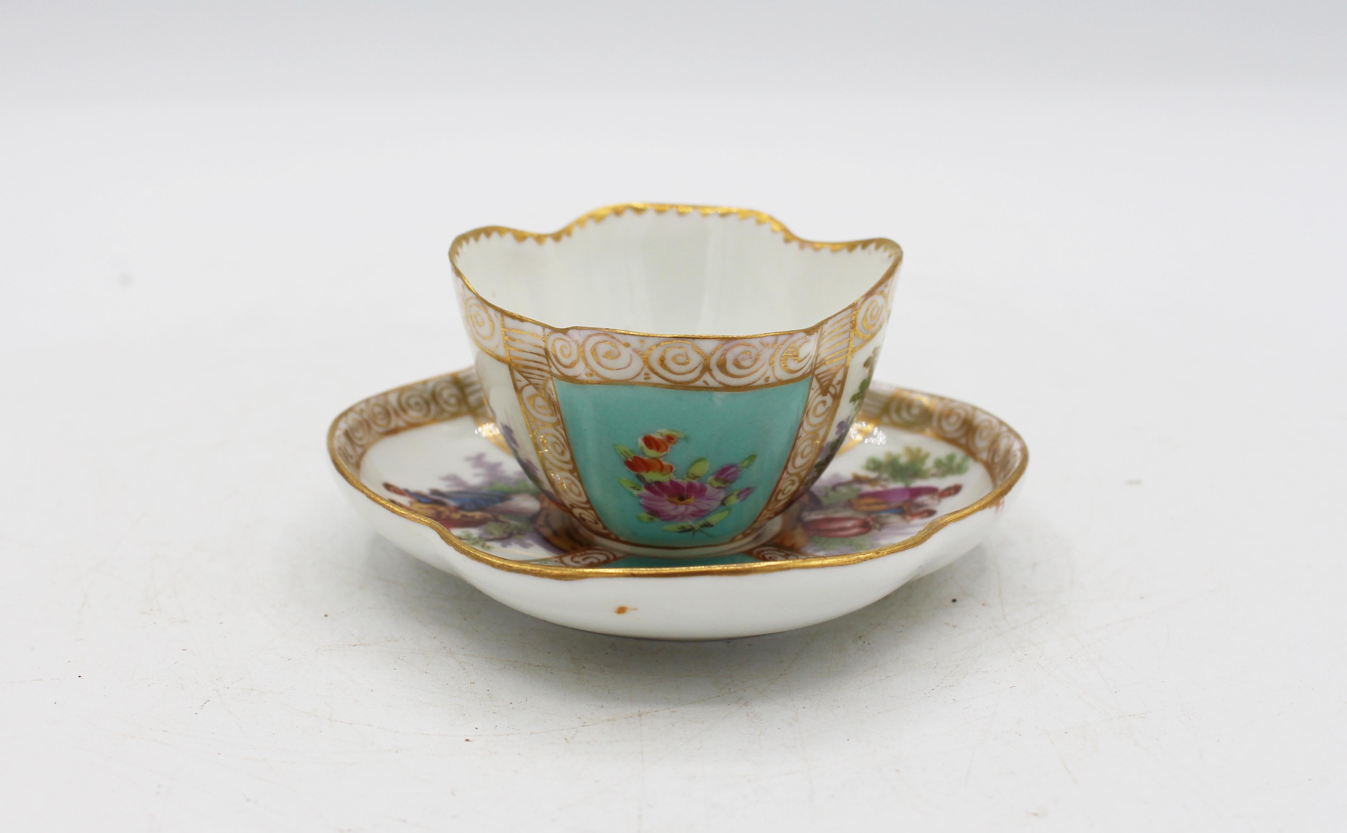 Circa 1888-1916 Richard Klemm, Dresden quatrefoil demitasse cup & saucer. Fully marked. Porcelain. Delicate scroll handle. Light blue-turquoise ground with handpainted 