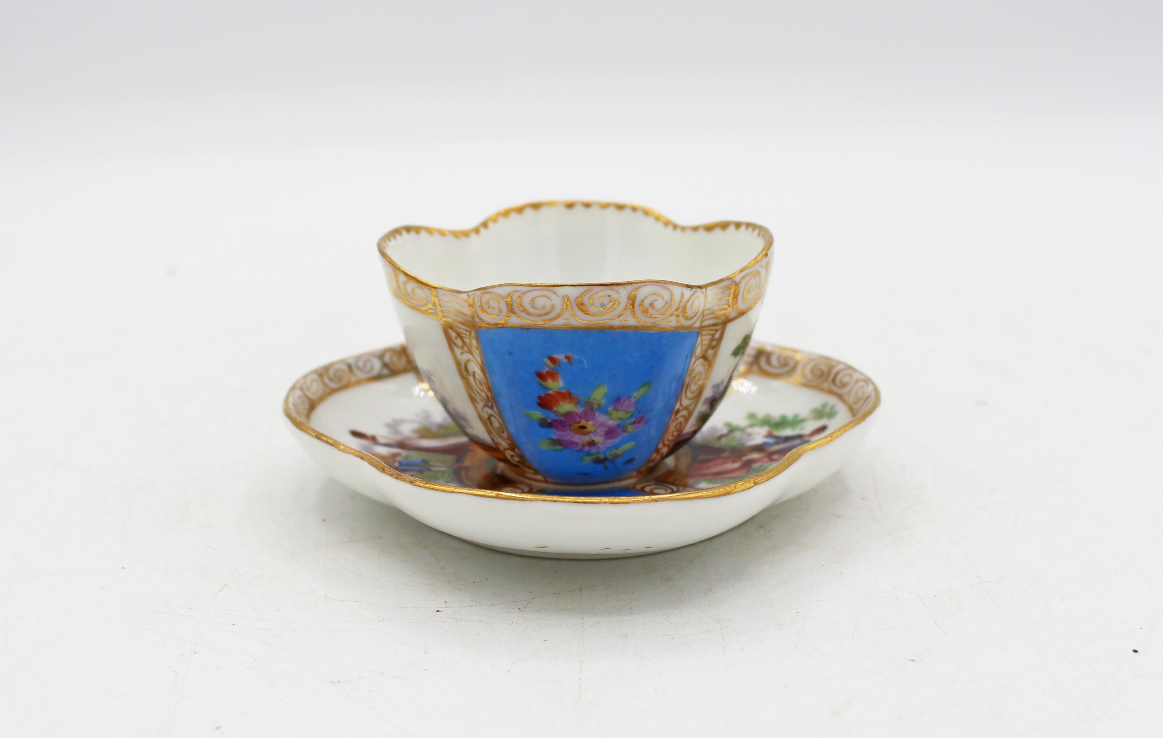 Circa 1888-1916 Richard Klemm, Dresden quatrefoil demitasse cup & saucer. Fully marked. Porcelain. Delicate scroll handle. Sky blue ground with handpainted 