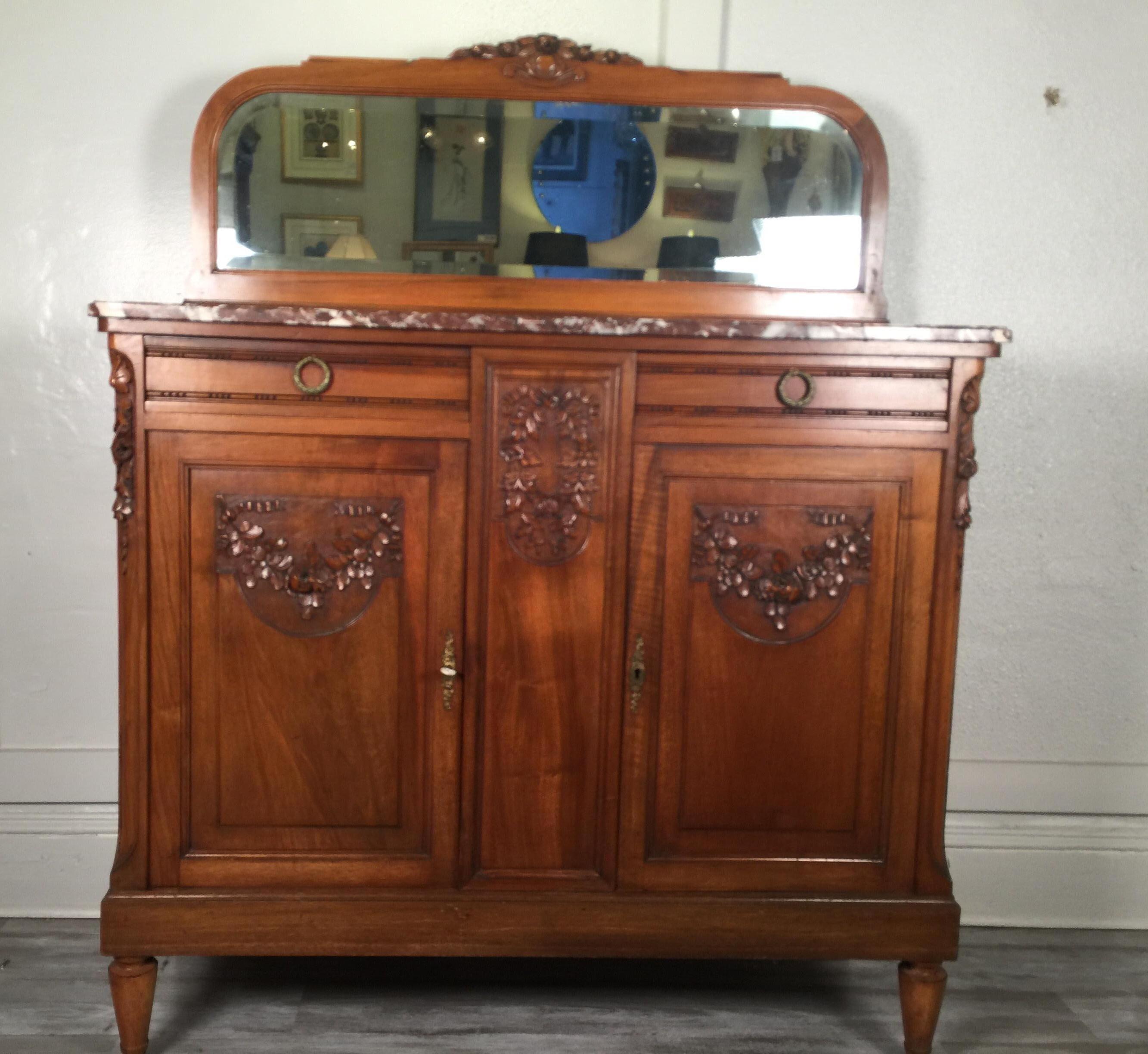French carved walnut two-door marble-top server with mirrored back, circa 1890-1900
Can be used as a server or as a dry bar dimensions: 48