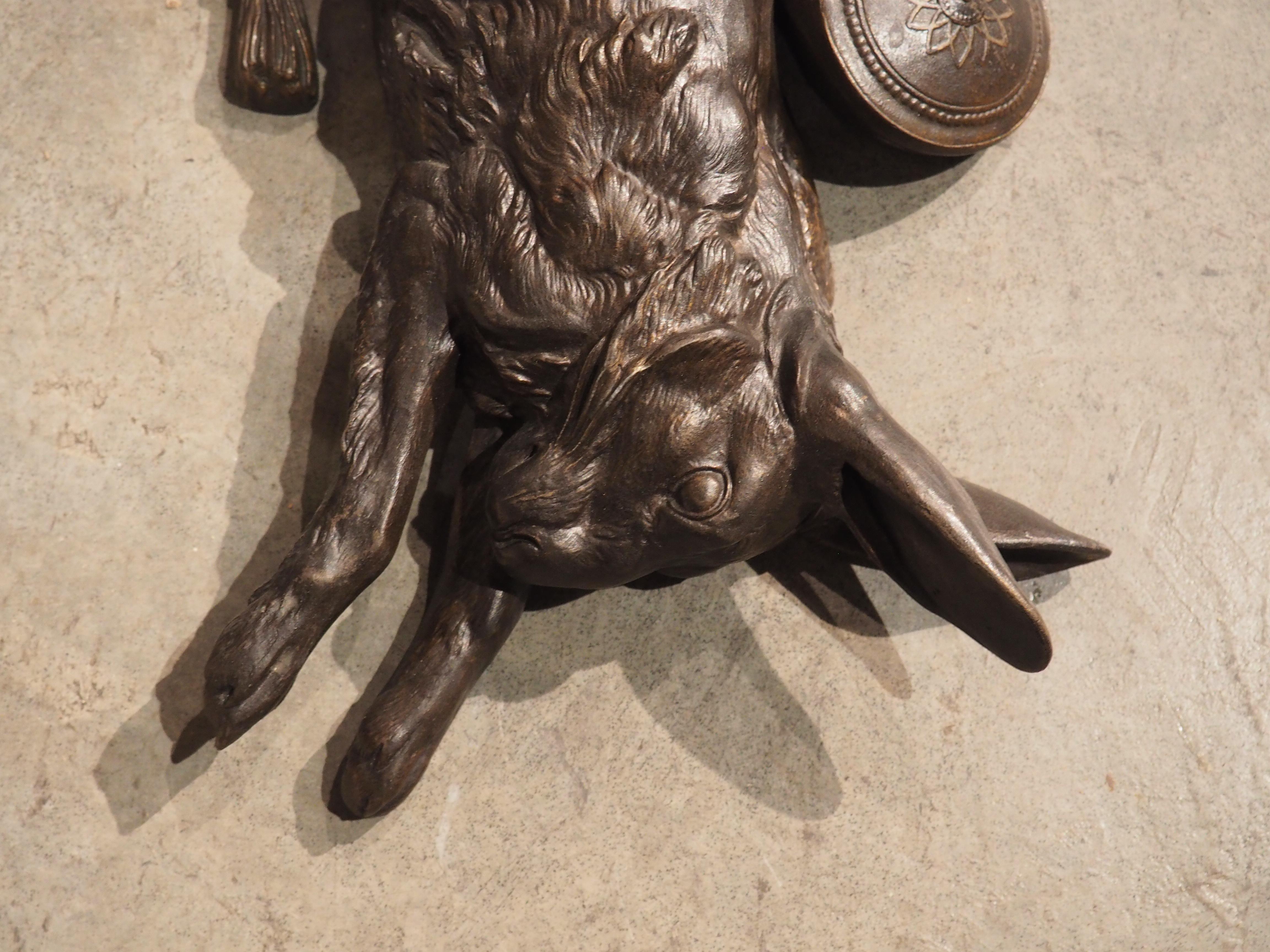 From France, circa 1890, our bronze wall hanging depicts a hunt trophy of a rabbit hanging upside down by one hind leg. This is a technique used for displaying felled game known as the Achilles tendon method. Behind the torso of the rabbit is a