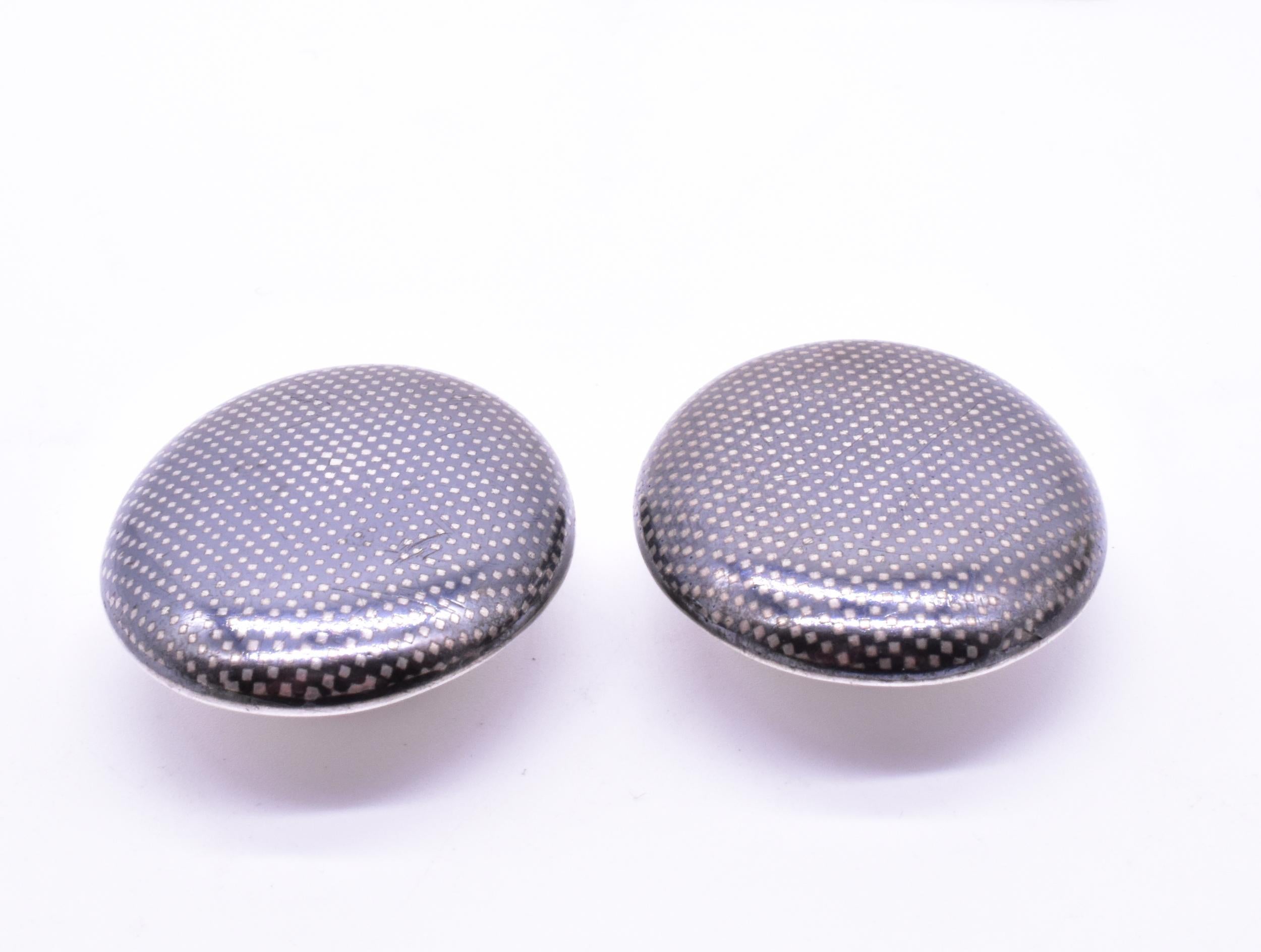 We love the pleasing niello design of the dotted squares on these substantial cufflinks. The word 