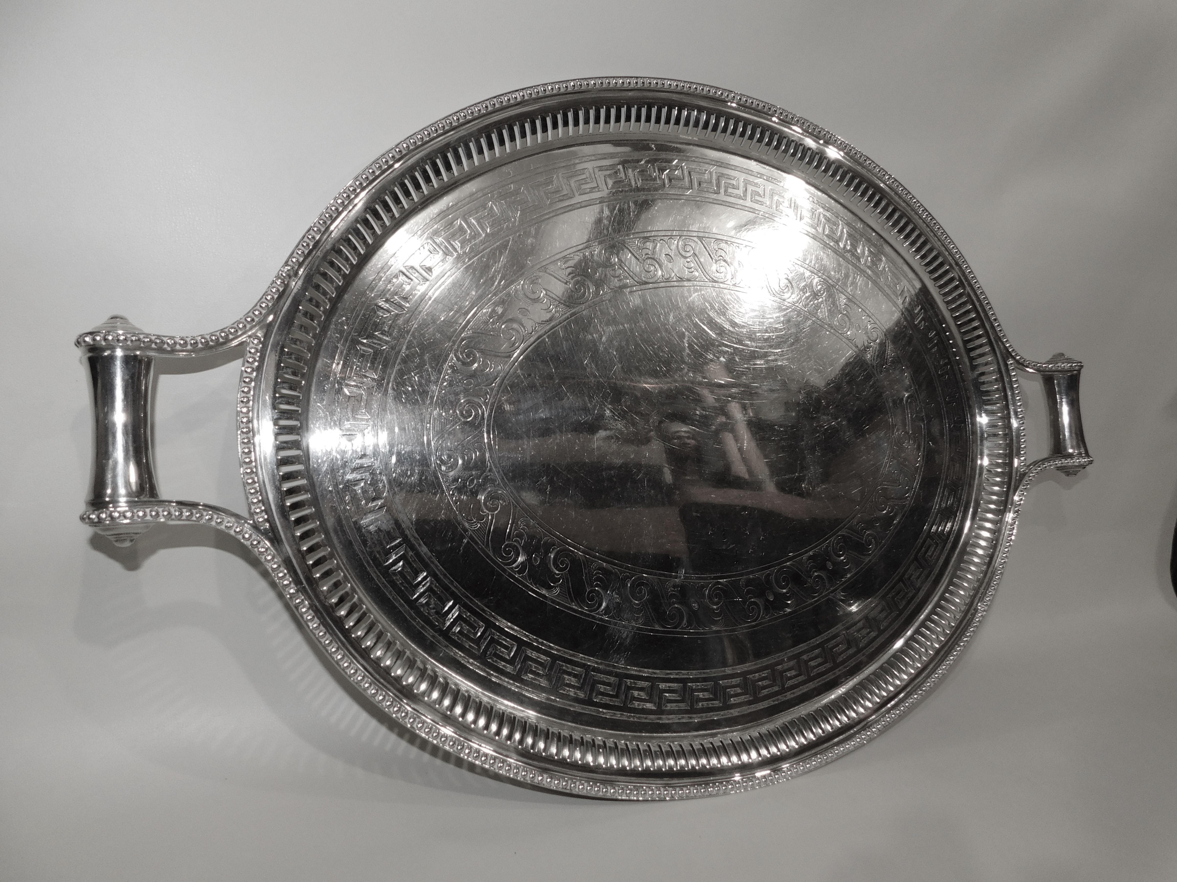 Large 19th century silver plated serving tray with ornate trim and handles.