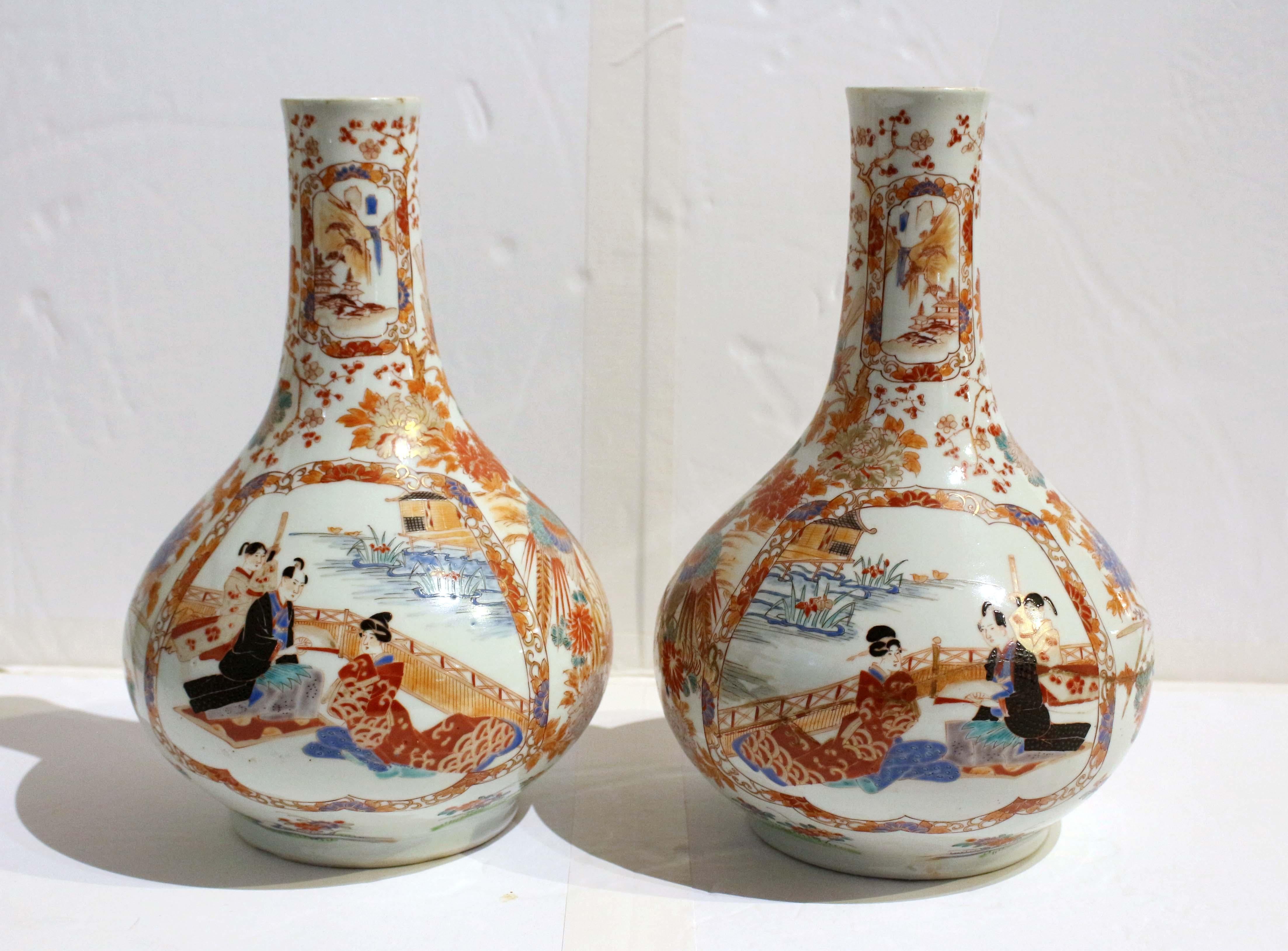 Circa 1890 pair of Imari vases, Japanese. Bulbous form. A true facing pair. Each with large opposing central medallions featuring a man with a fan with assistant behind with his sheathed sword and seated lady in long robe beside the water under a