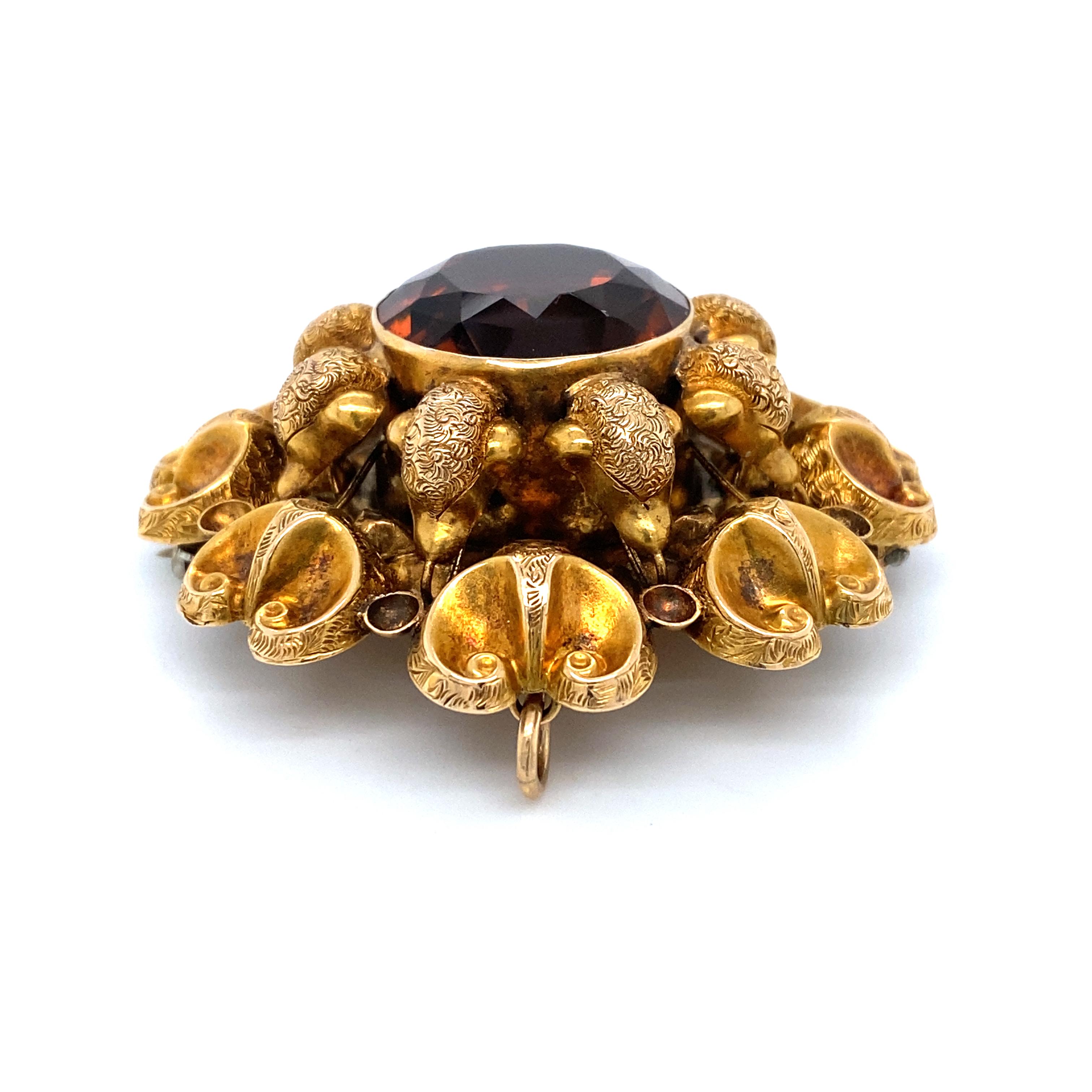 Item Details: This unique brooch is a beautiful Victorian era creation with a motif that evokes a ram's head. The citrine in the venter is a deep orange-brown and is excellent quality.

Circa: 1890s
Metal Type: 15 Karat Gold
Weight: 18.5 grams
Size: