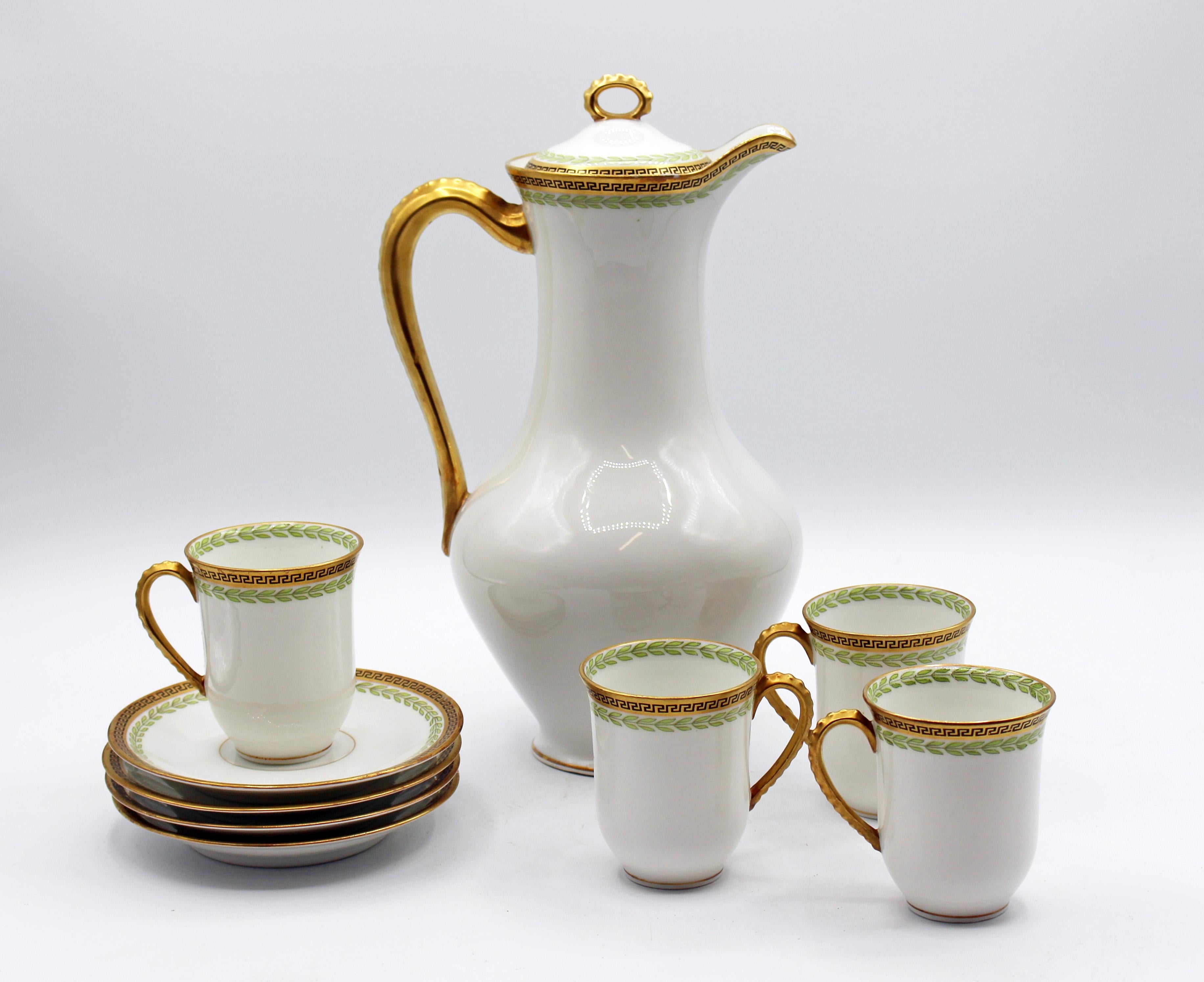 French C.1890s porcelain chocolate set for four. The ewer form covered pot with four cups and saucers (also ideal as demitasse) in Empire/Classical taste decorated with green laurel leaves with black Greek key accented gilt borders and shaped, gilt