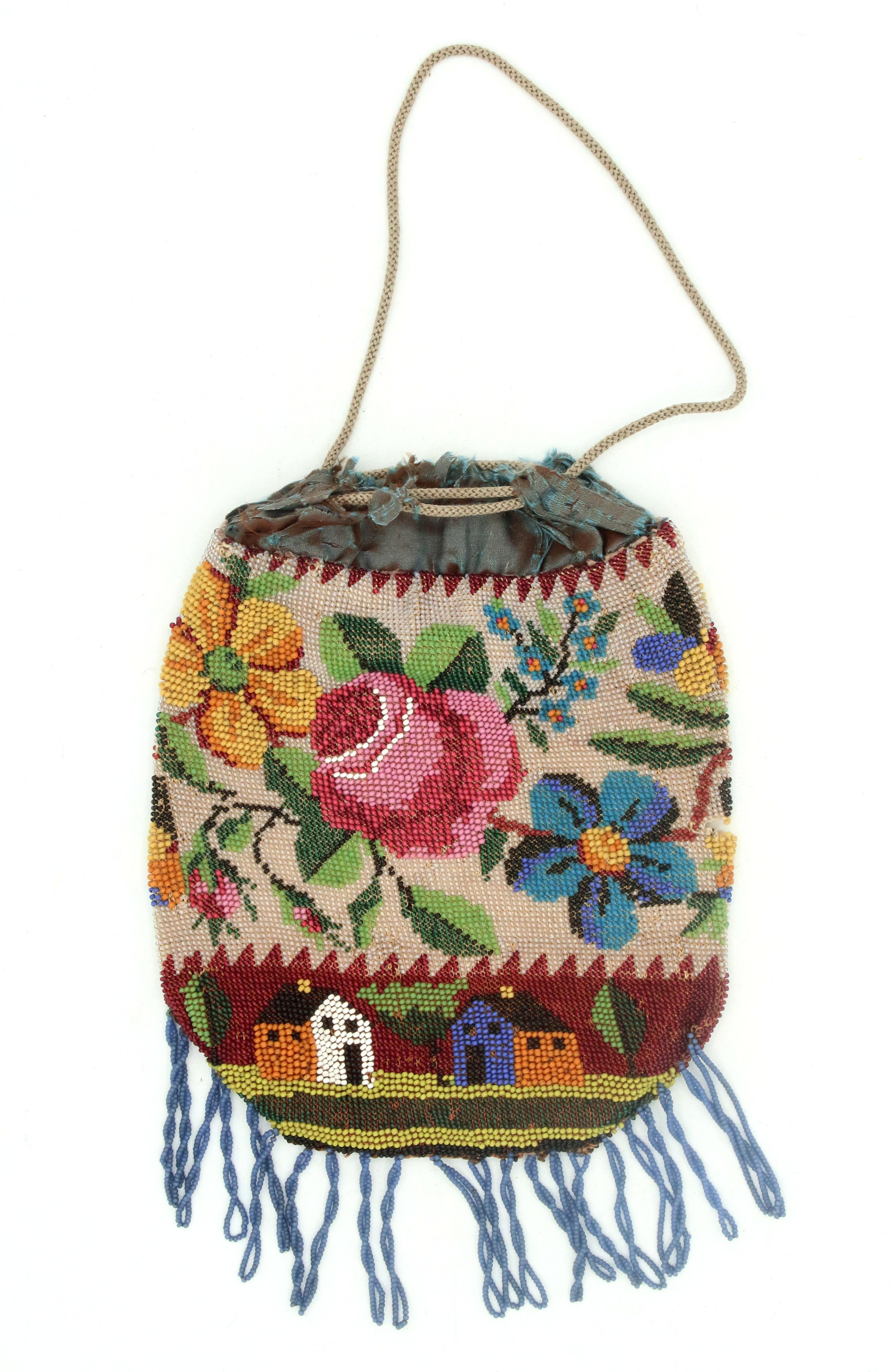 circa 1890s micro-beaded draw-string evening bag. Scenic design with Shaker Style houses appears in various bag designs & color variations. Silk lining is fragile with some tatters. Small tear in beading on mid-side.

8