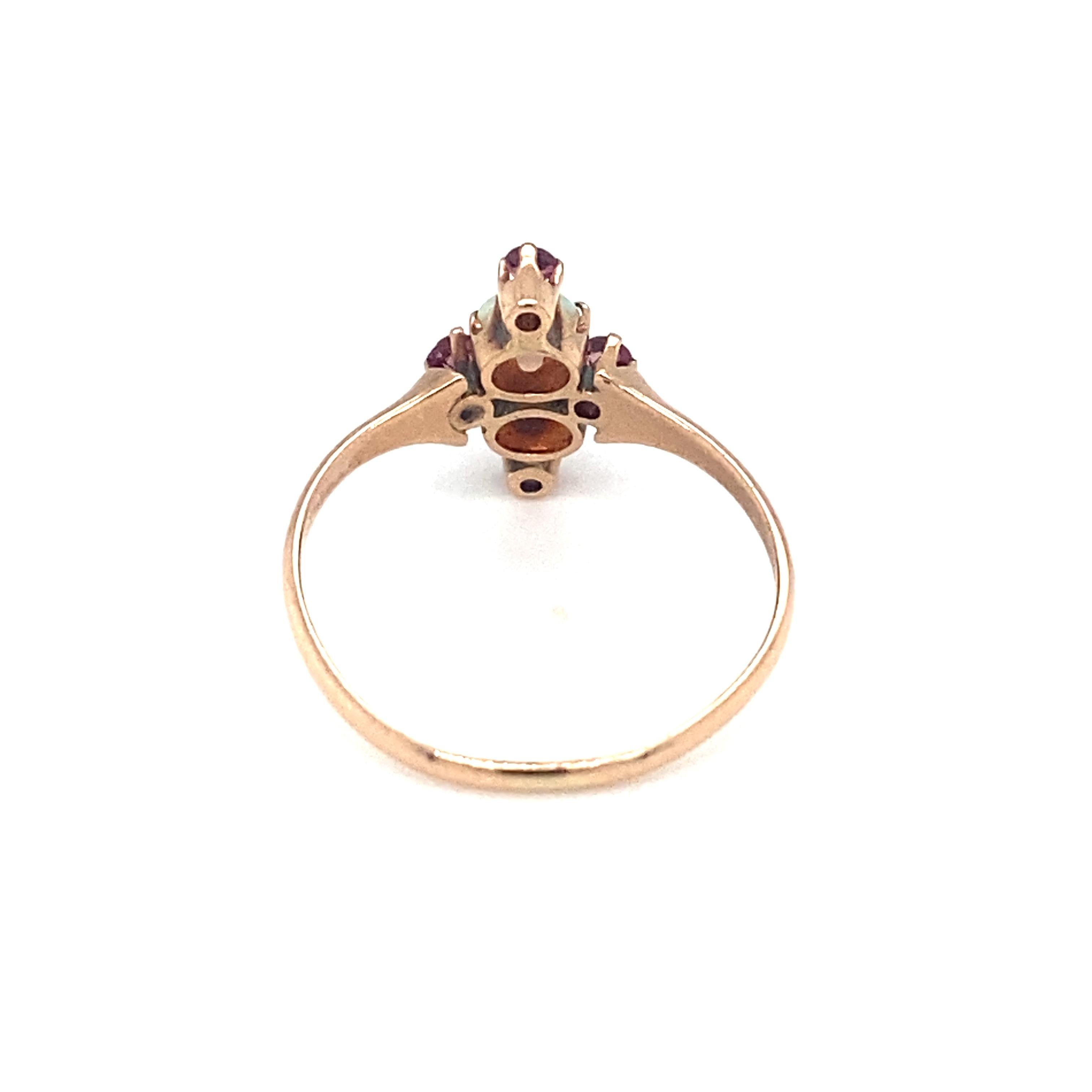 Item Details: This extremely unique antique ring features pink sapphires from Sri Lanka and opals from Ethiopia. It dates back to the 1890s, later Victorian era and is crafted in 9 Karat Yellow Gold. Dainty and unique, it features a beautiful and