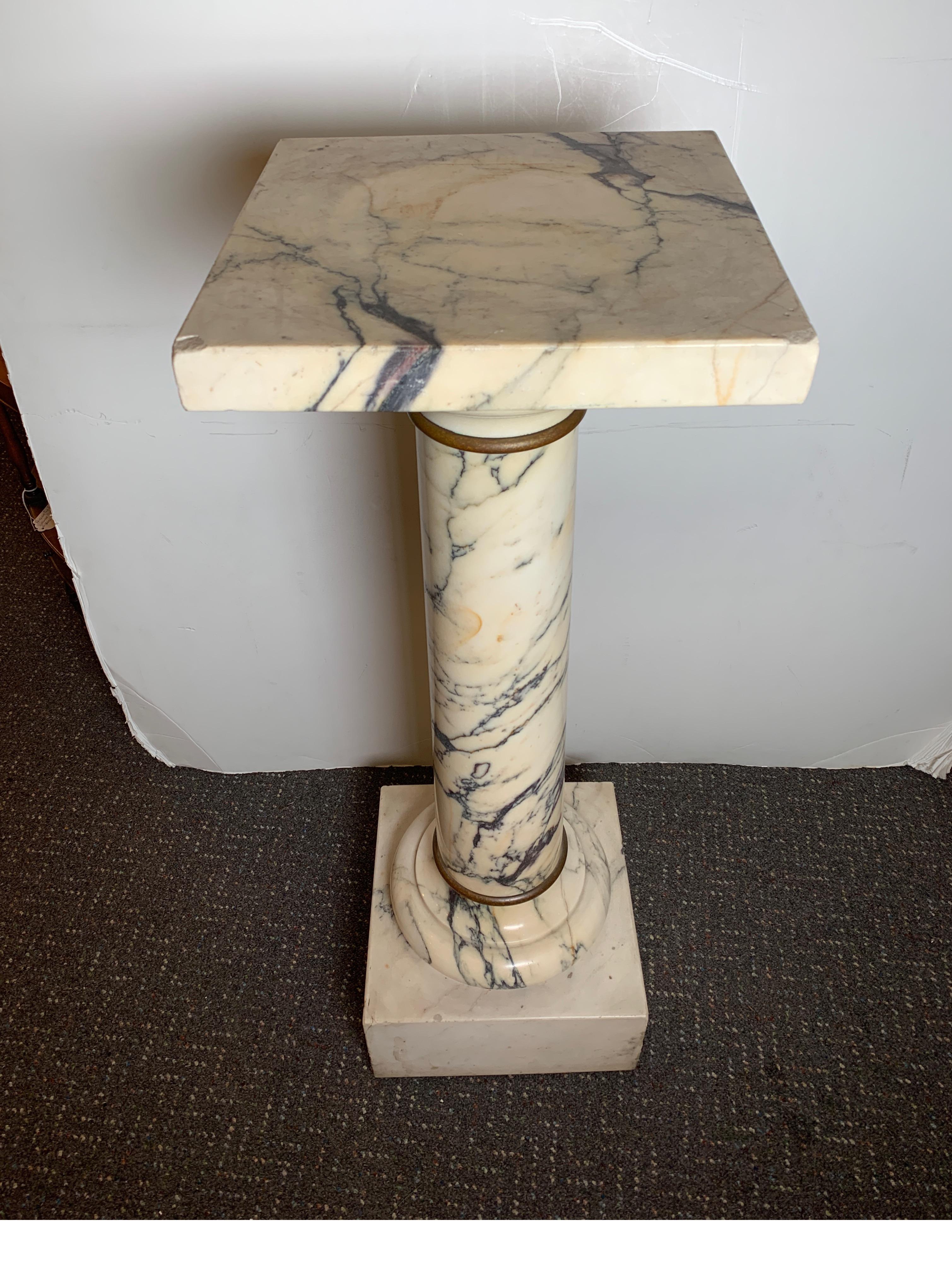 Traditional Italian Marble Pedestal W/ Simple Bronze Ring Accents, circa 1890s.
Nice size and weight to accommodate heavy sculptures
Dimensions: 37