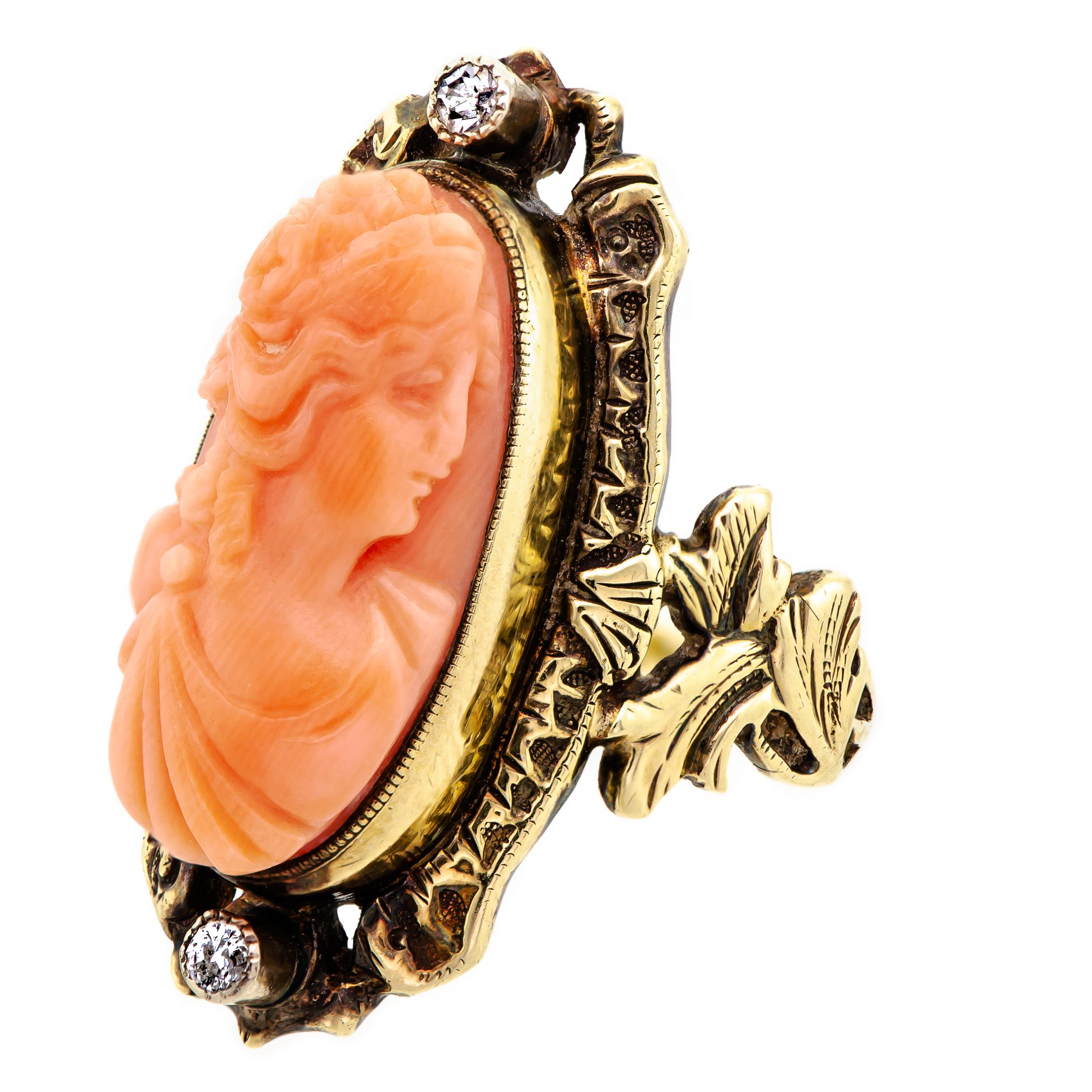 Lovely circa 1895 late Victorian coral cameo and diamond ring centrally bezel set with an oval-shaped light orange coral cameo of a 