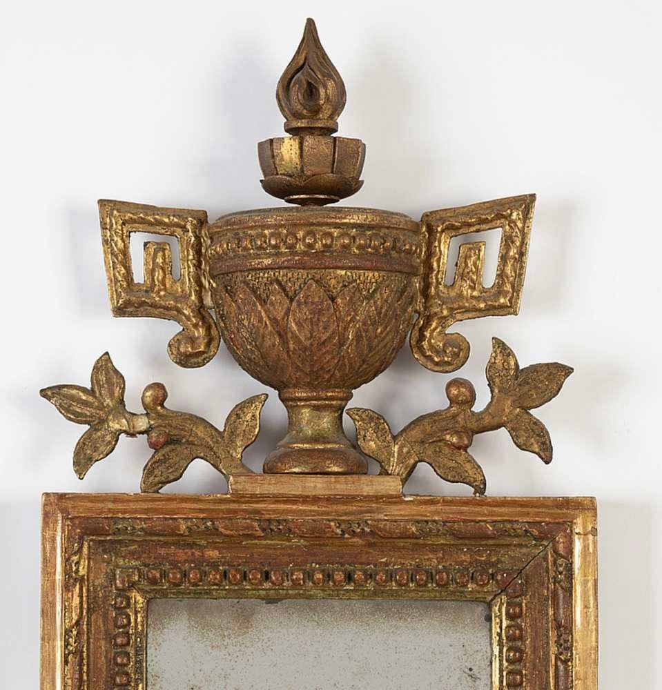Late circa C18th Swedish Gustavian gilt mirror with classic urn, leaf and swag detail.
The glass has been replaced over the years.