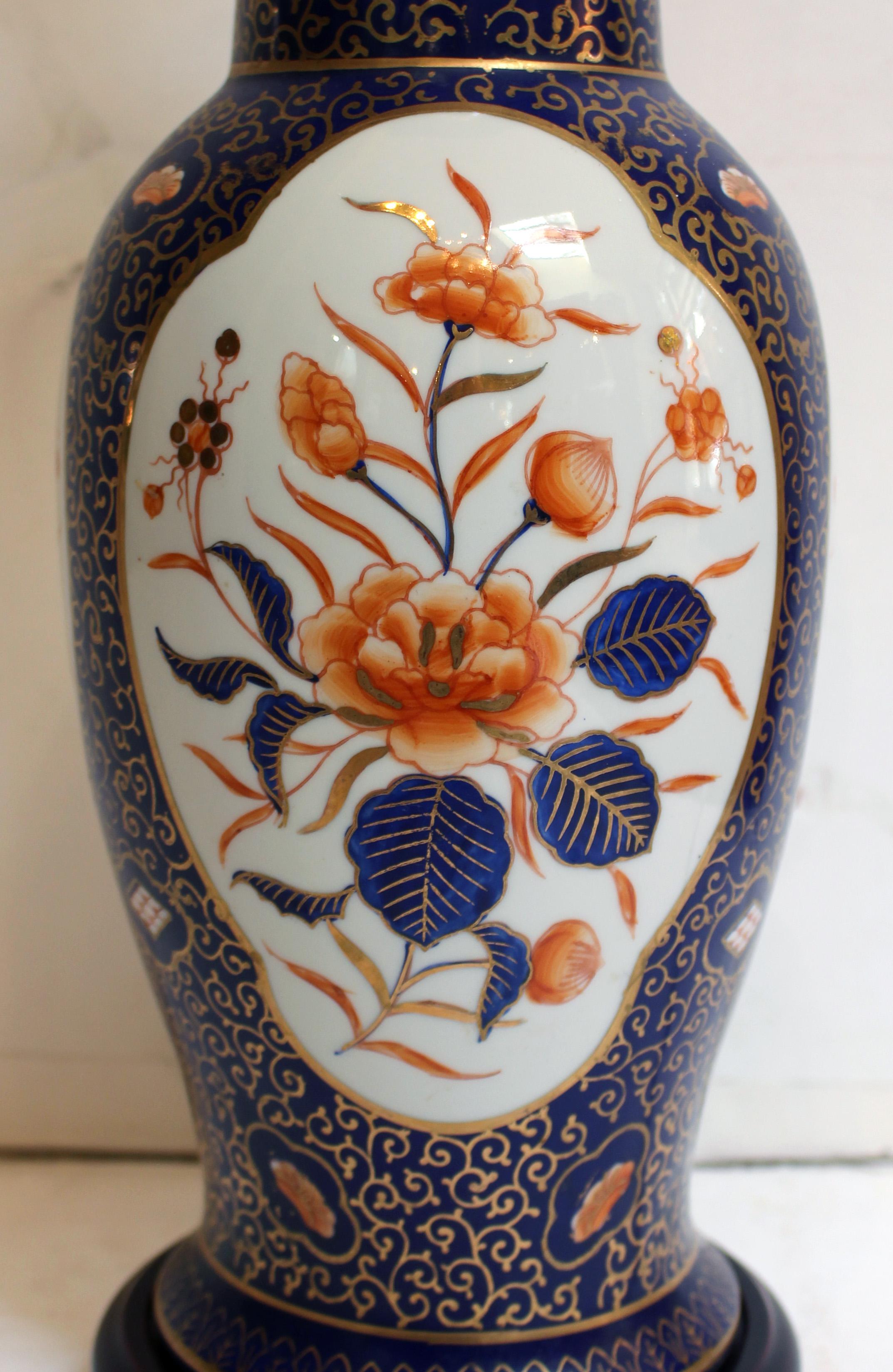 Circa 1900-1920 Japanese vase now mounted as a lamp. Antique cobalt & orange floral reserve porcelain vase made for the Western market, mounted as a lamp in the mid-20th century. Some gilt rubbed. 
Vase: 16.25