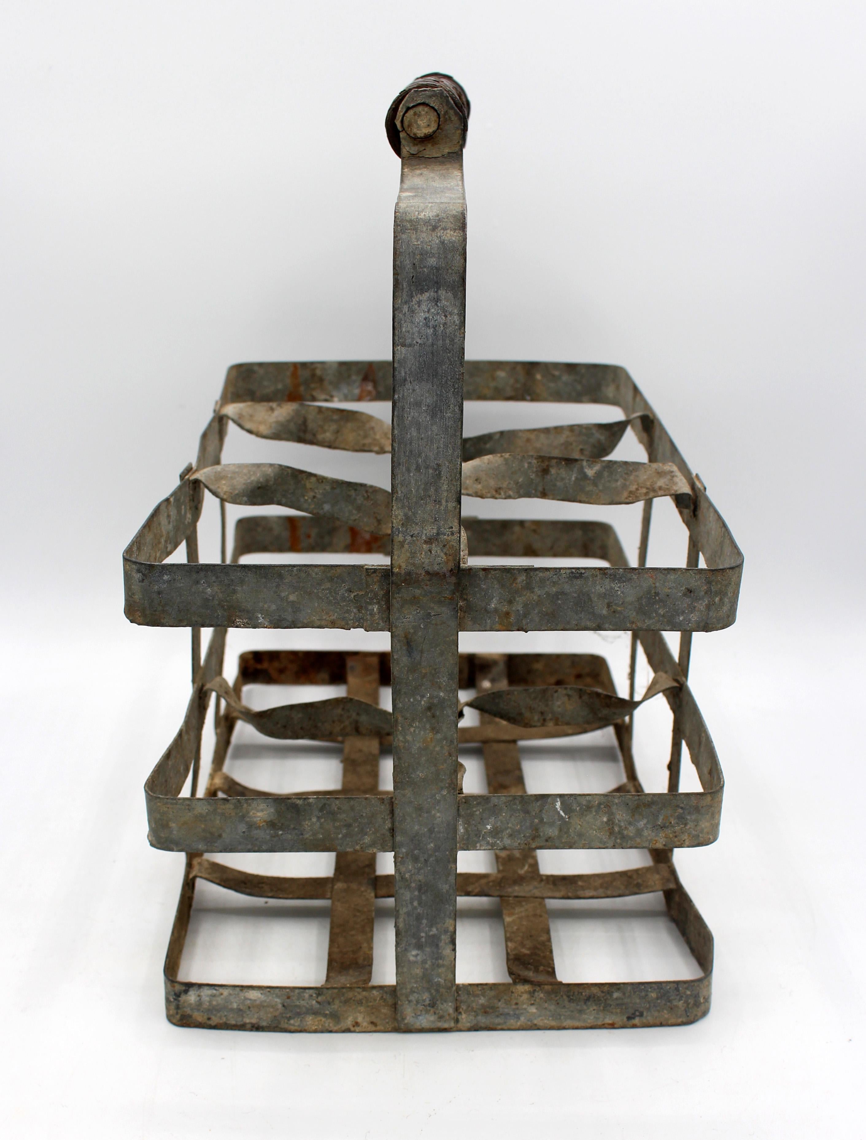 Circa 1900 French zinc & turned wood 6-bottle wine carrier. Shaped, ring turned carrying handle (loss to underside of handle). Six bottle compartments. With crusty finish, bends & dings as expected with age, use & material. 12