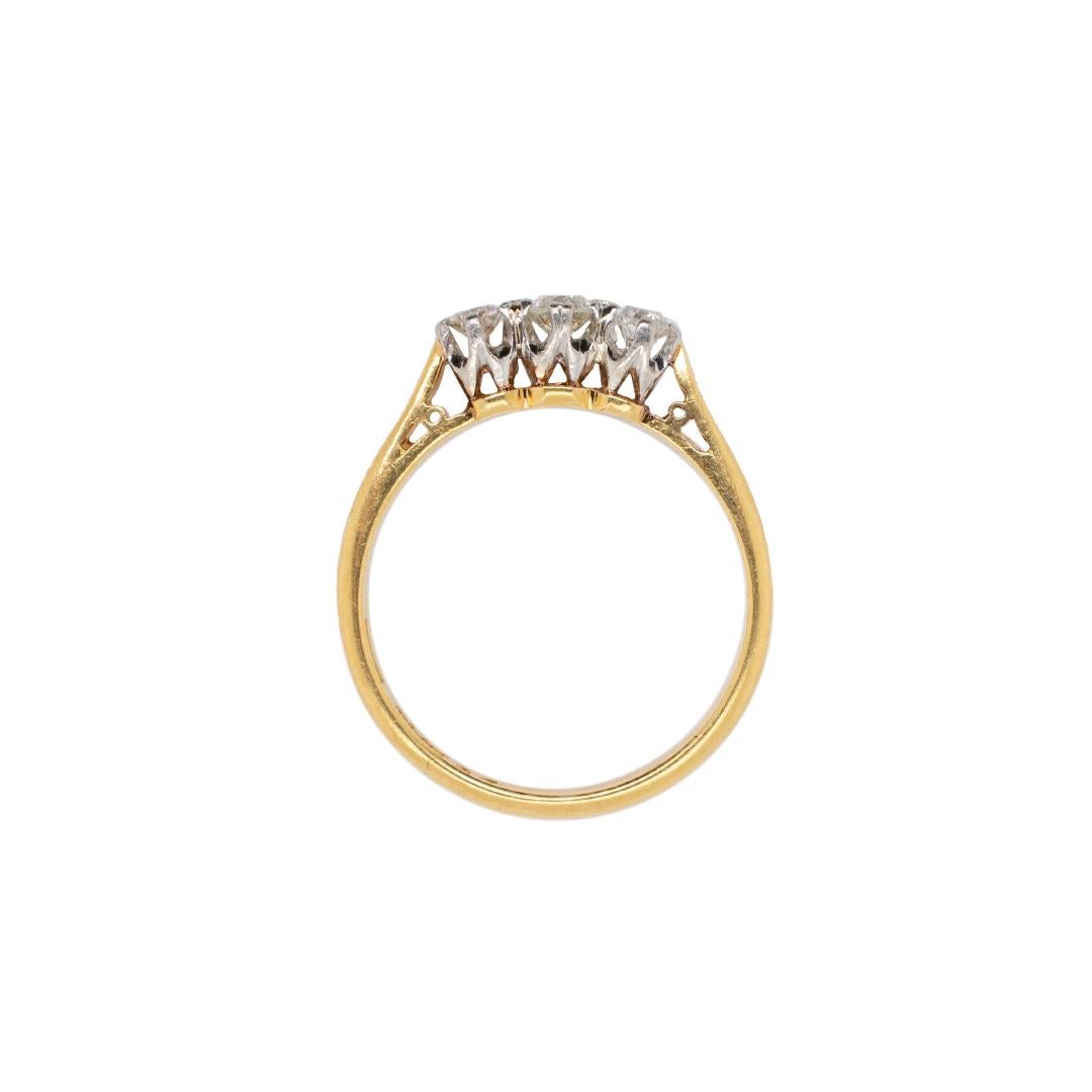 One lady's hand made hand engraved, filigree-style, 18K yellow gold and platinum three-stone, diamond antique, vintage, three-stone ring with a half round shank. The ring is a size 7.25. The ring weighs a total of 2.90 grams. Engraved with 