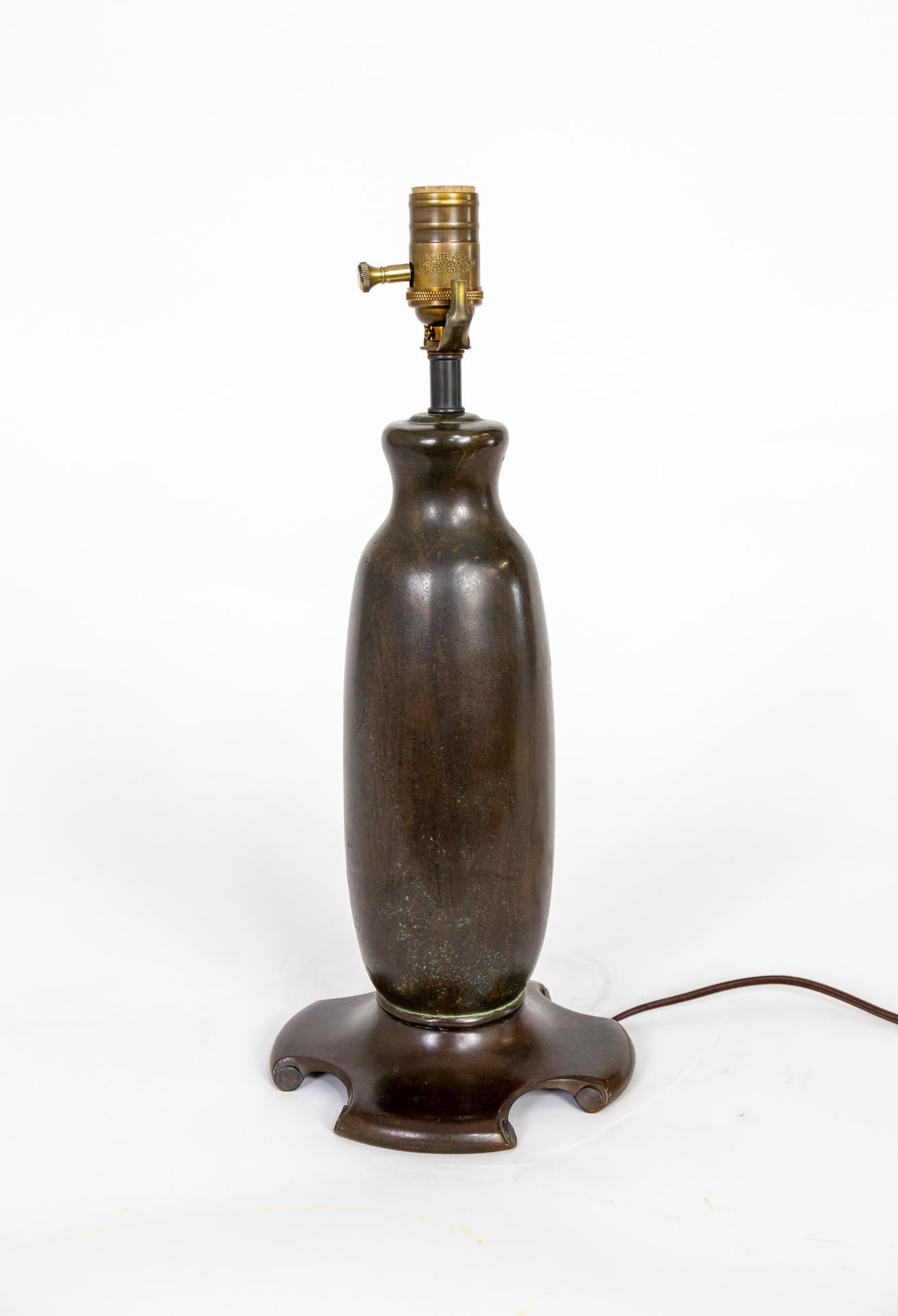 A heavy bronze table lamp in a beautiful shape, with a unique base and and original, rich patina with subtle green speckles. American, circa 1900. Newly wired with a dimmer socket. Measures: 18