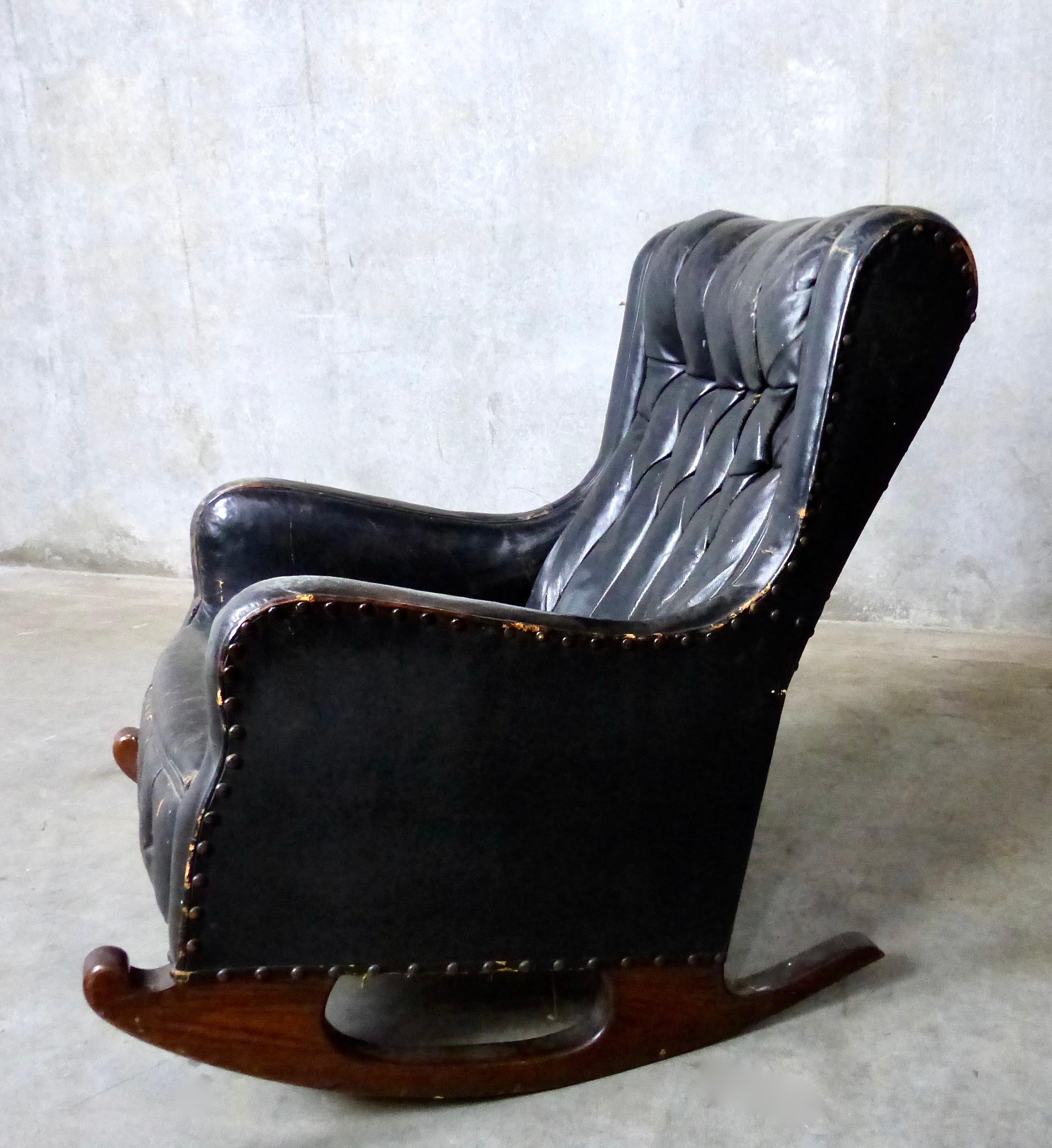 A circa 1900 leather black leather wingback style chair on solid wooden rockers. Tufted leather with horsehair interior. Style to spare in a compact rocking chair. Found in Eastern Canada.
Minor wear and tear but structurally sound.
Dimensions: