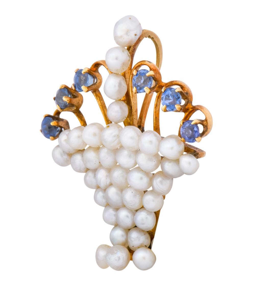 Pendant designed as a basket set throughout with round natural pearls measuring approximately 3.0 mm, cream in body color with silver and rosé overtones

With gold wire stems terminating in prong set Swiss cut sapphires weighing approximately 0.24