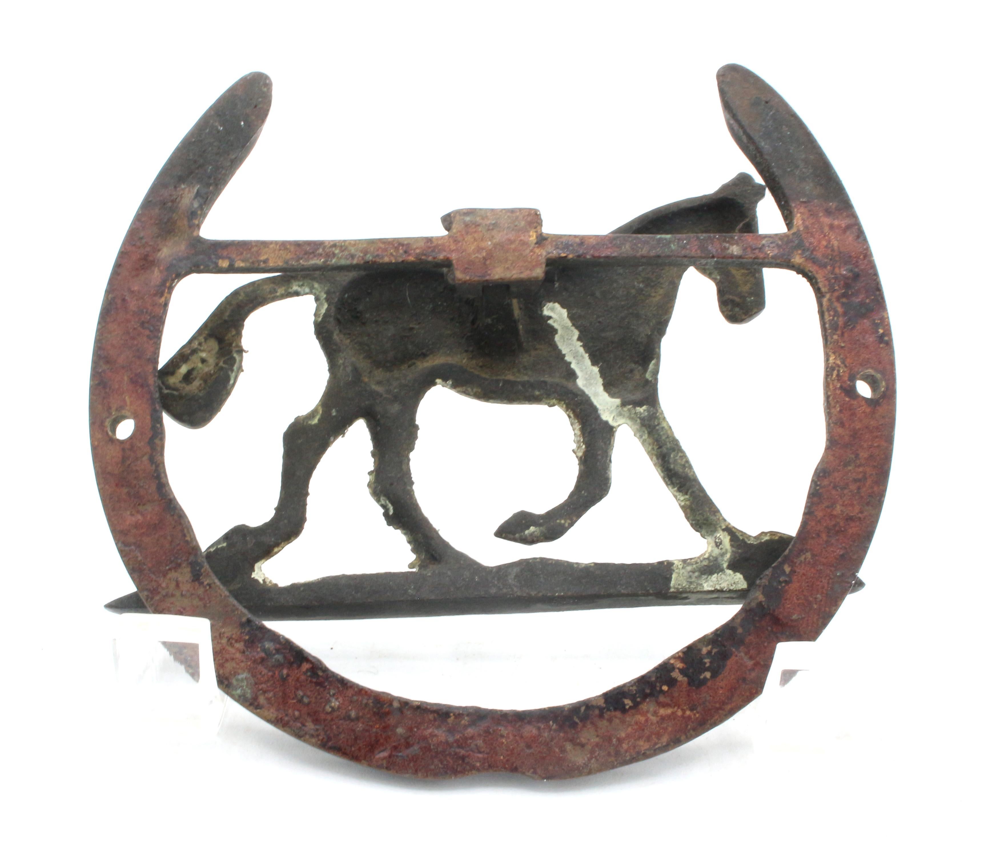 Iron horse & horse shoe door knocker, English, circa 1900. The horse trotting along is the knocker with the horseshoe as the door mount.
4 5/8