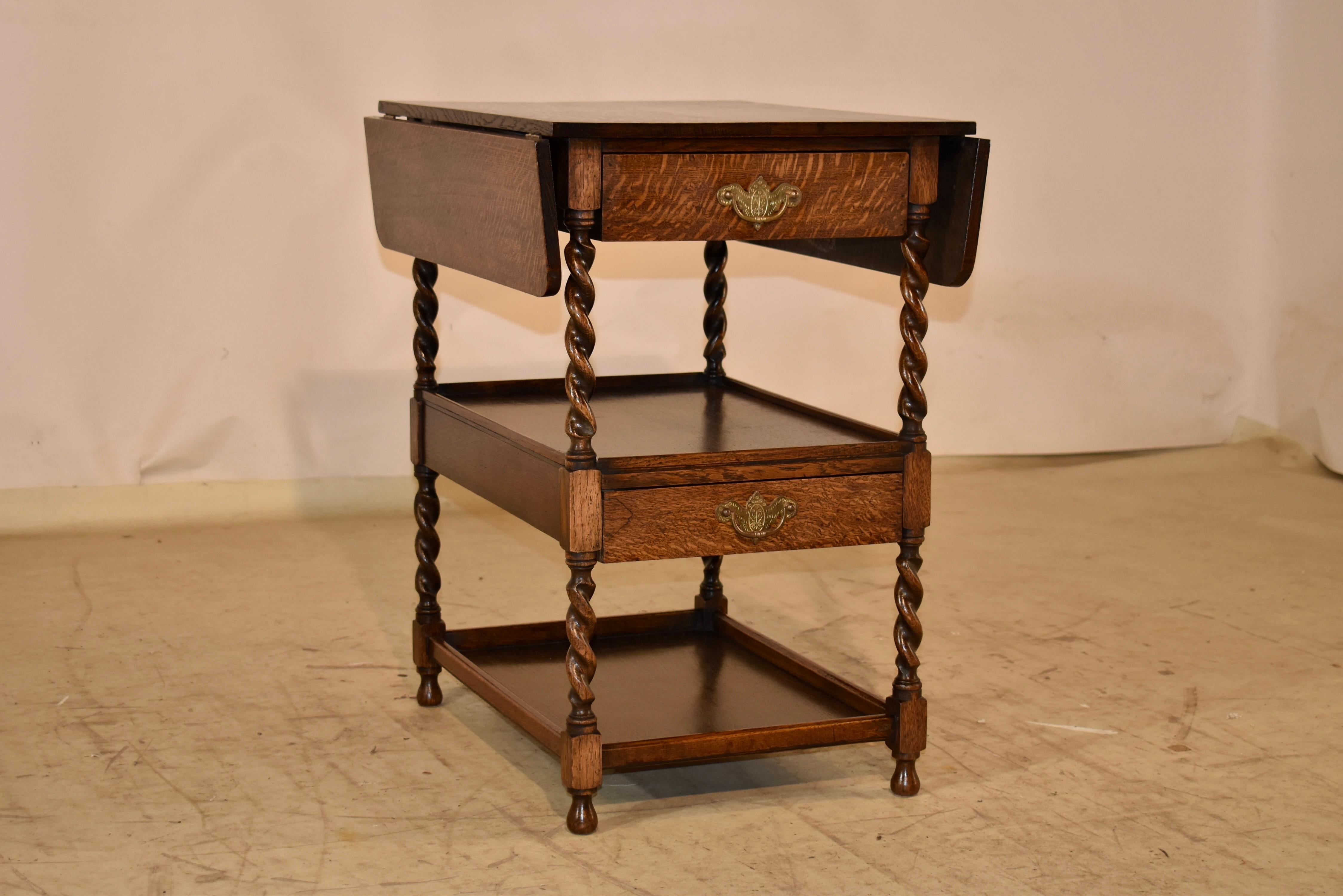 Circa 1900 period Edwardian drink cart with two leaves.  The top, with leaves extended, measures 30.5 x 24.  The leaves have supports underneath that pull out for easy use and stability.  The top follows down to a simple apron and has two lower