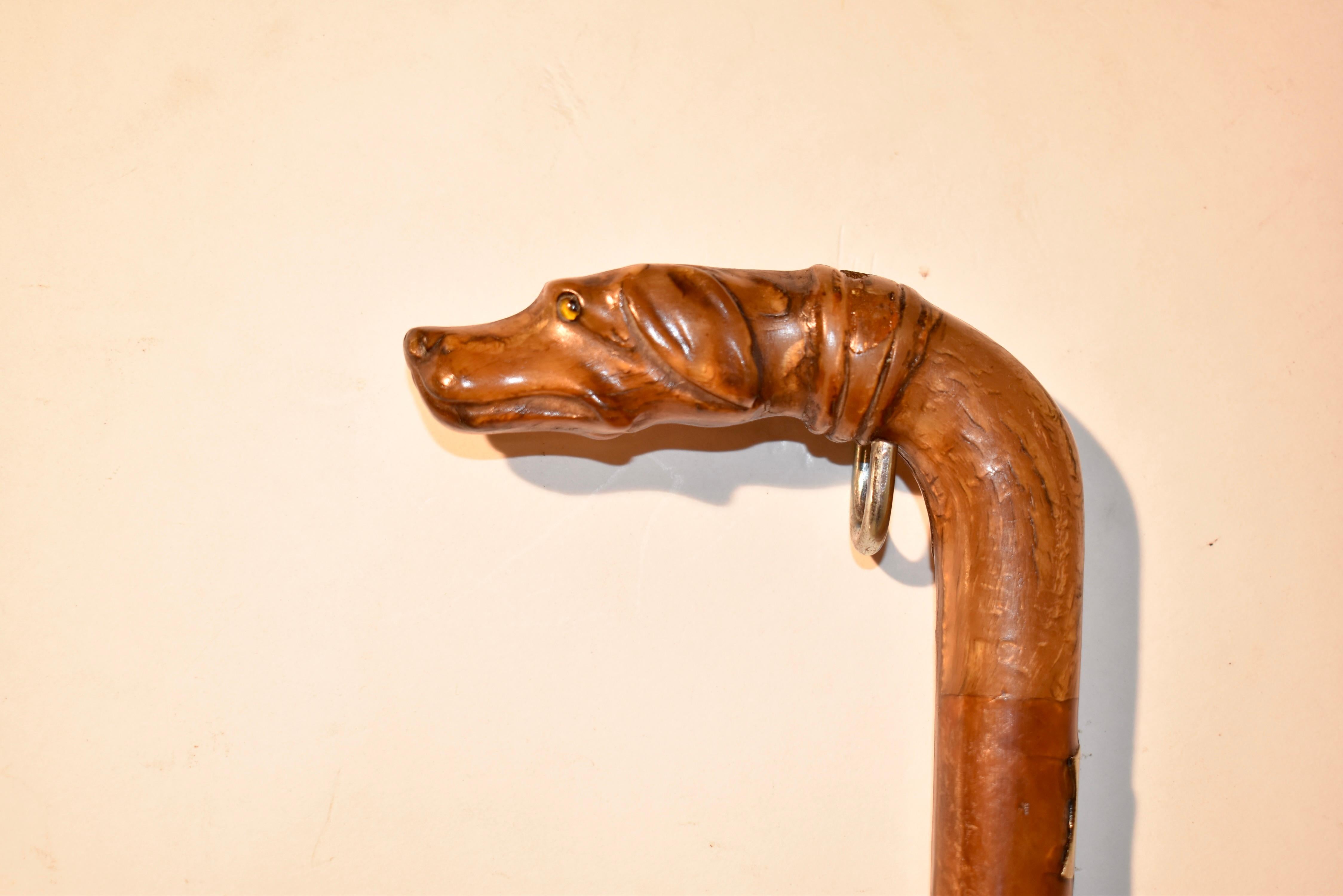 Circa 1900 Edwardian sword cane or walking stick with a lovely dog's head handle.  the handle appears to be made from celluloid, and is in the form of a dog's head.  The cane itself is made from cherry.  The handle, when pulled up, has a sword